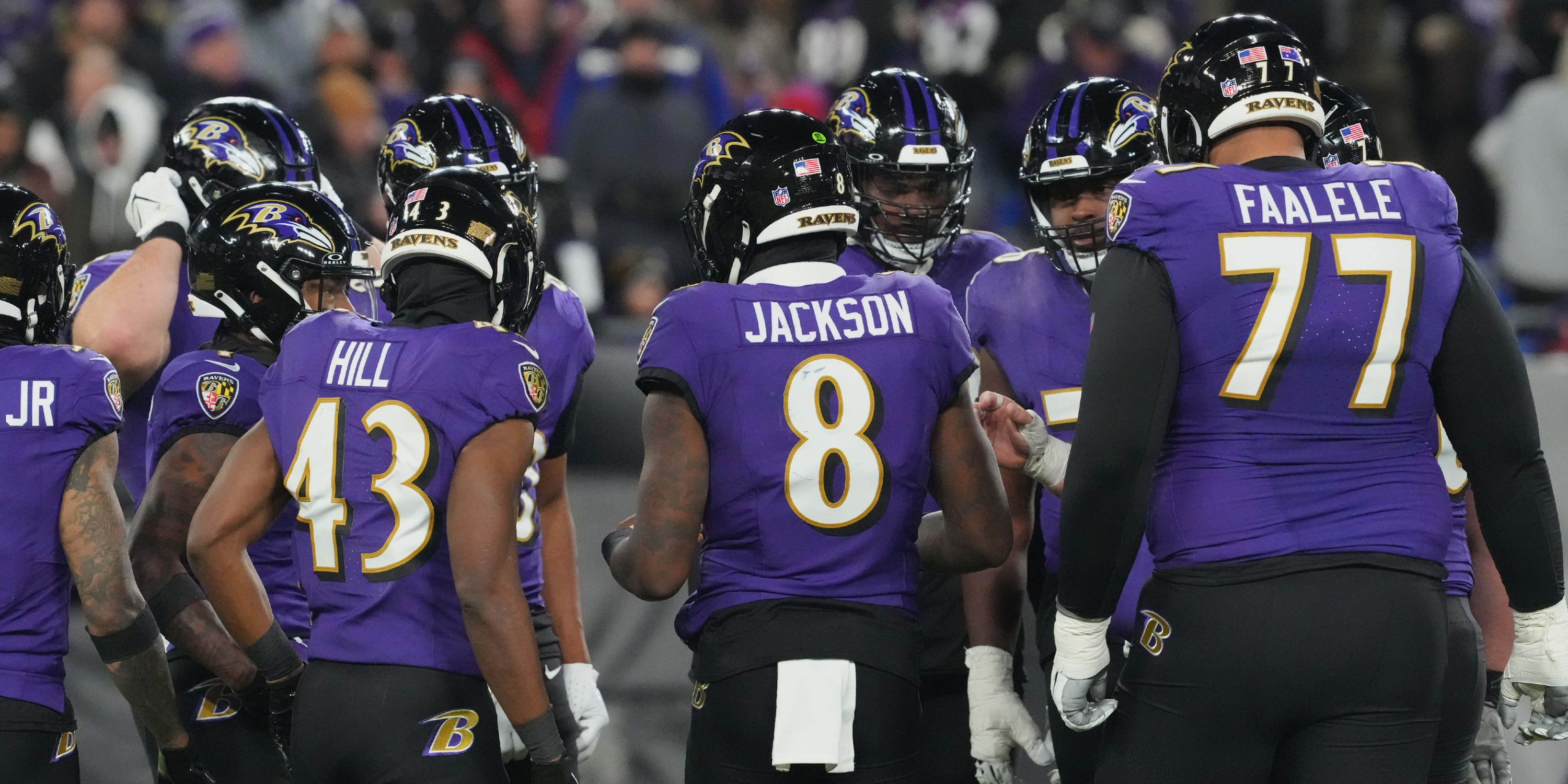 Baltimore Ravens offense in presnap huddle Lamar Jackson