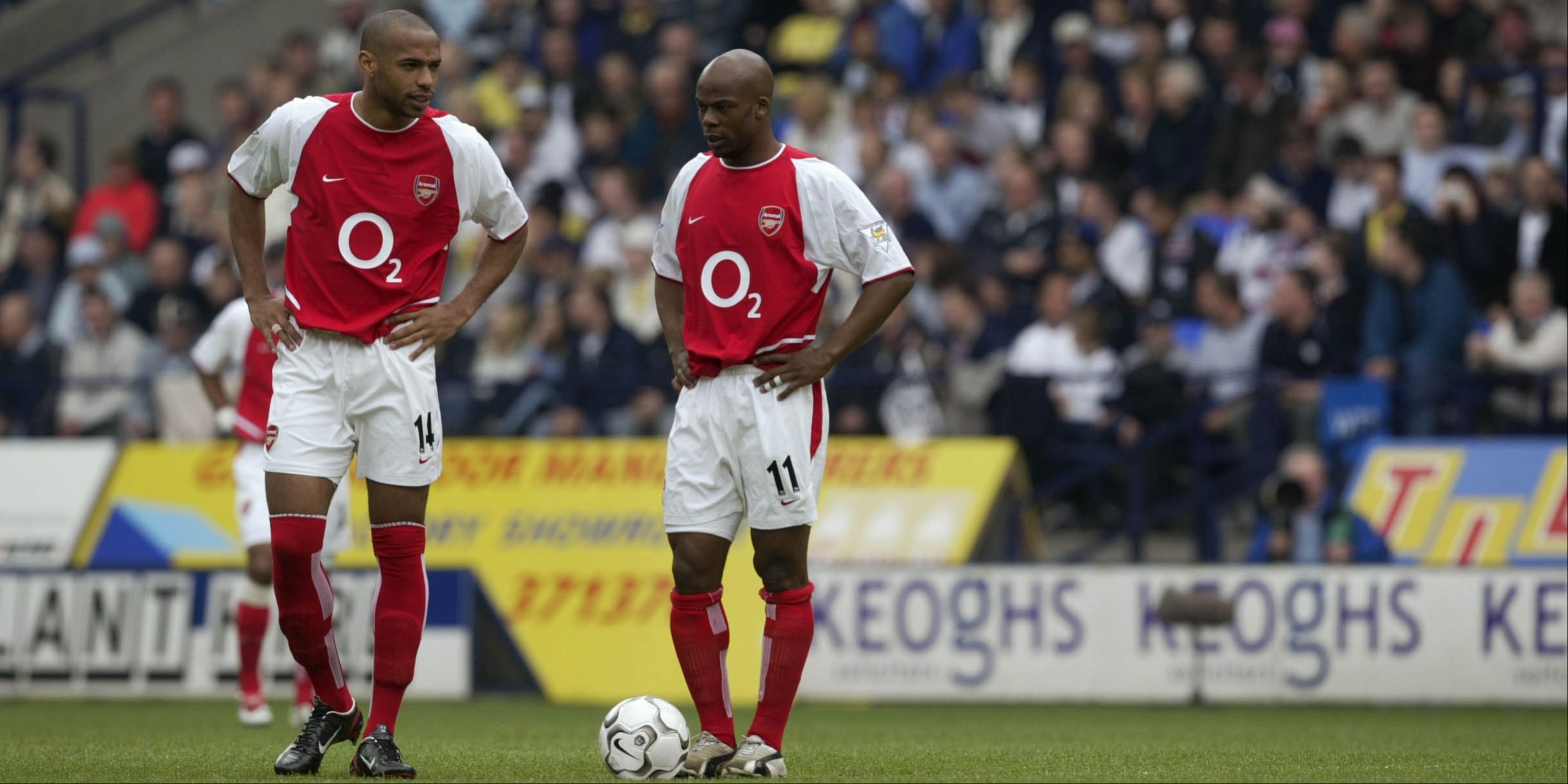 Arsenal's Thierry Henry and Sylvain Wiltord stand over the ball looking dejected.