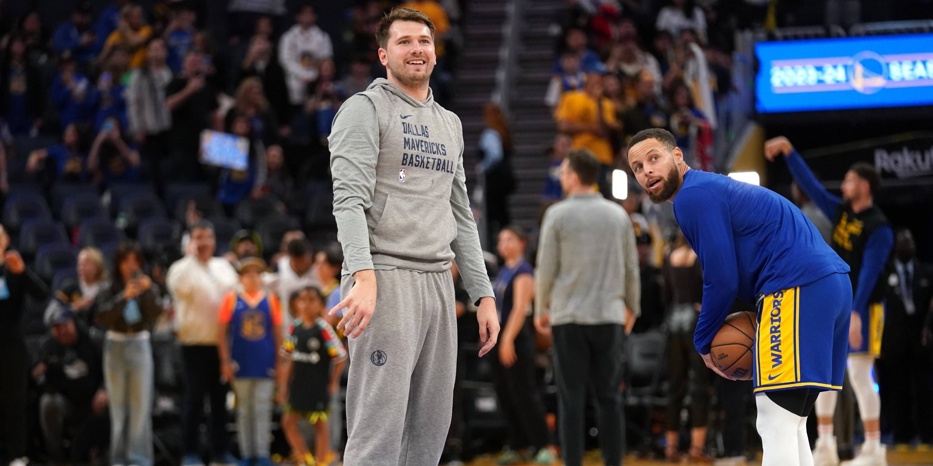 Luka Dončić and Stephen Curry warm up before a game.