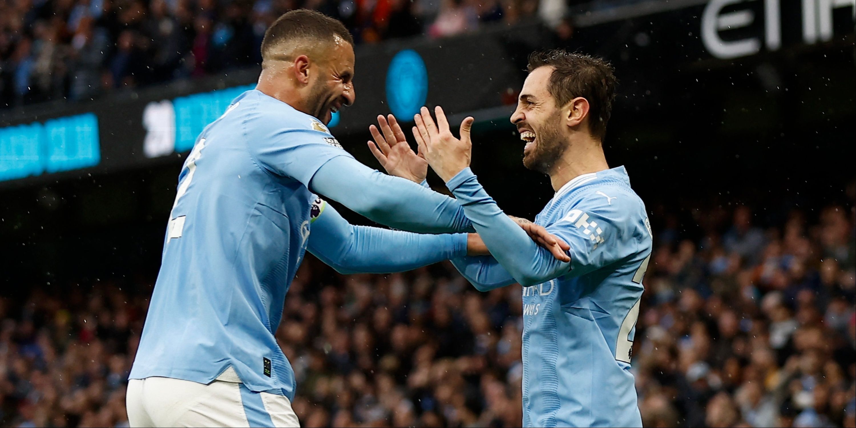 Manchester City's Bernardo Silva and Kyle Walker celebrate together. 