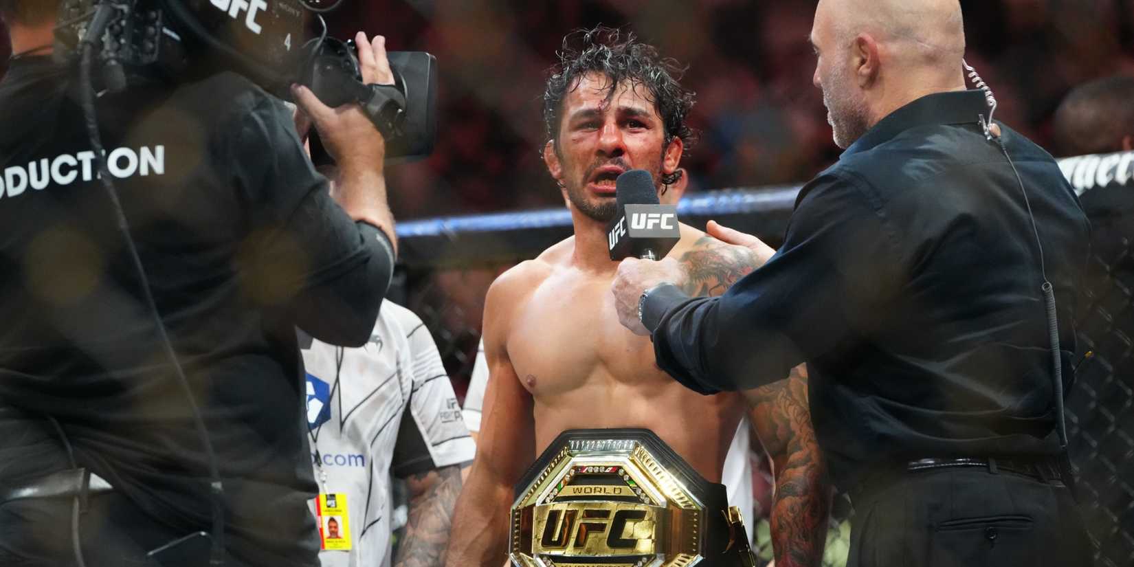 Alexandre Pantoja celebrates winning UFC title