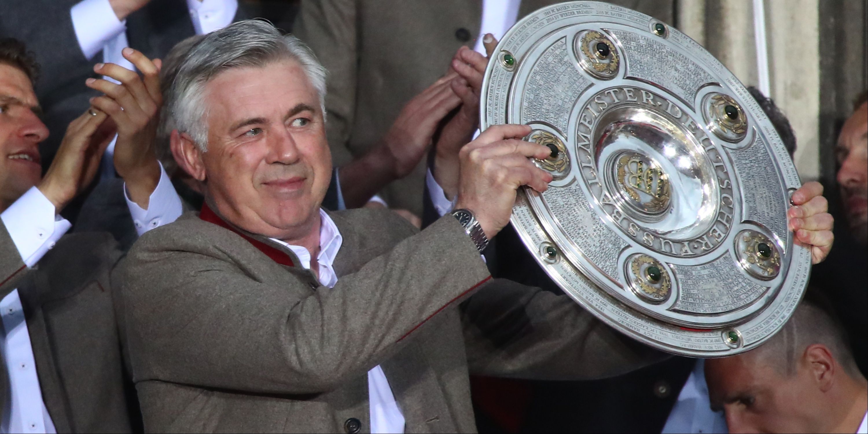 Carlo Ancelotti lifting a trophy