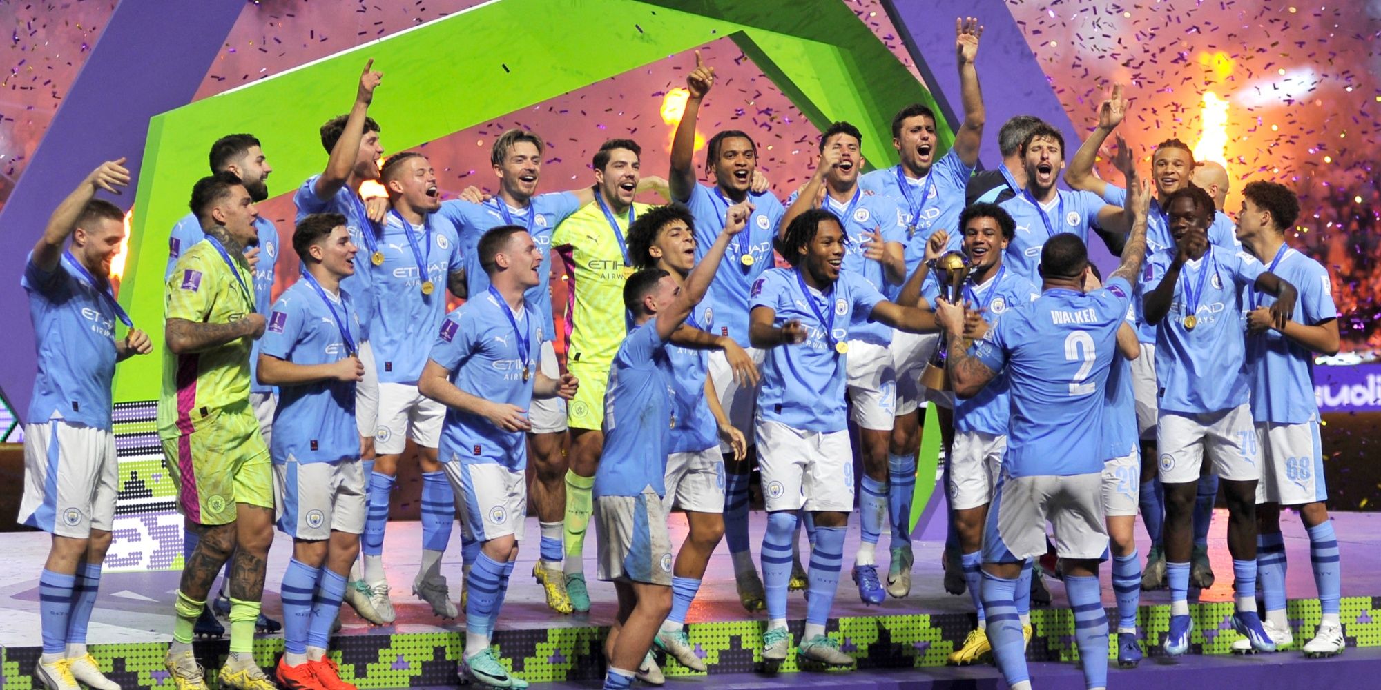 Manchester City players celebrate with the trophy on the podium after winning the Club World Cup final