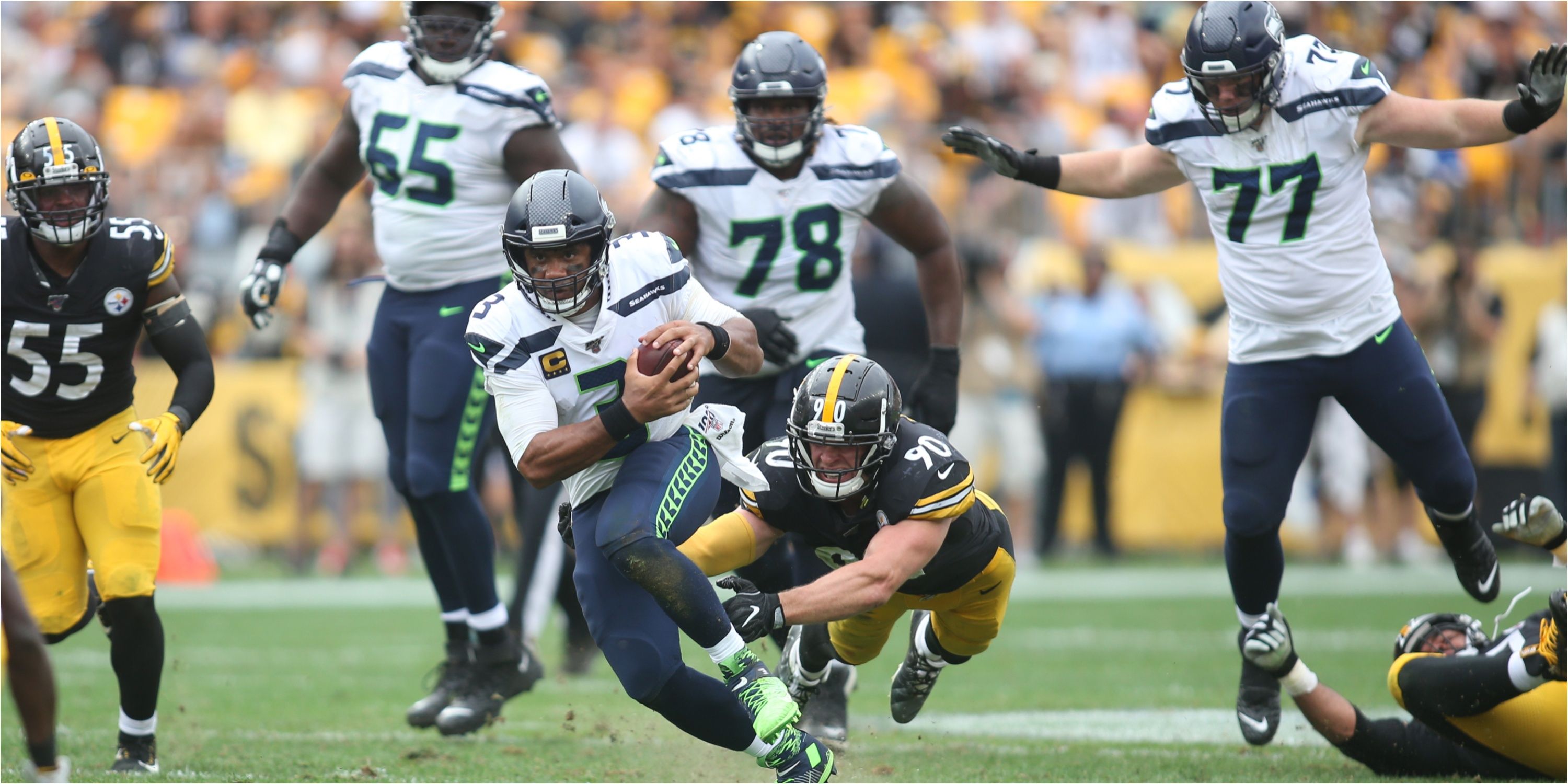 Seattle Seahawks QB Russell Wilson runs with the ball. 