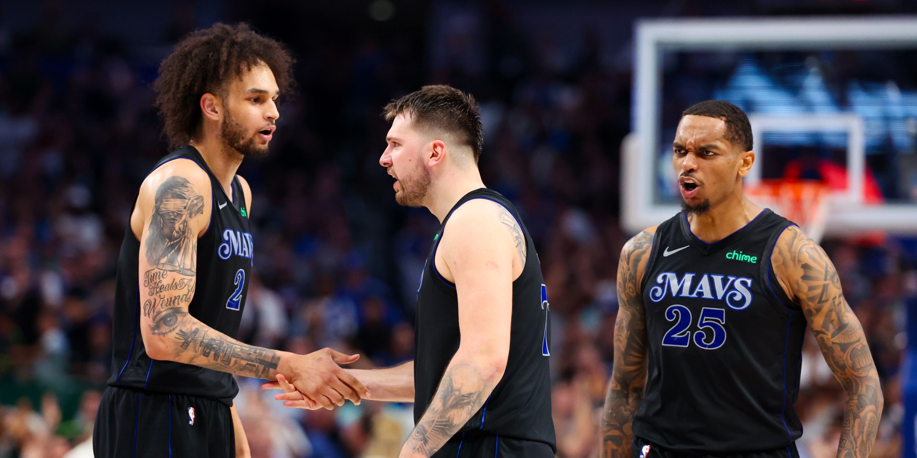 Luka Doncic giving a dap to Dereck Lively II with PJ Washington hyped up