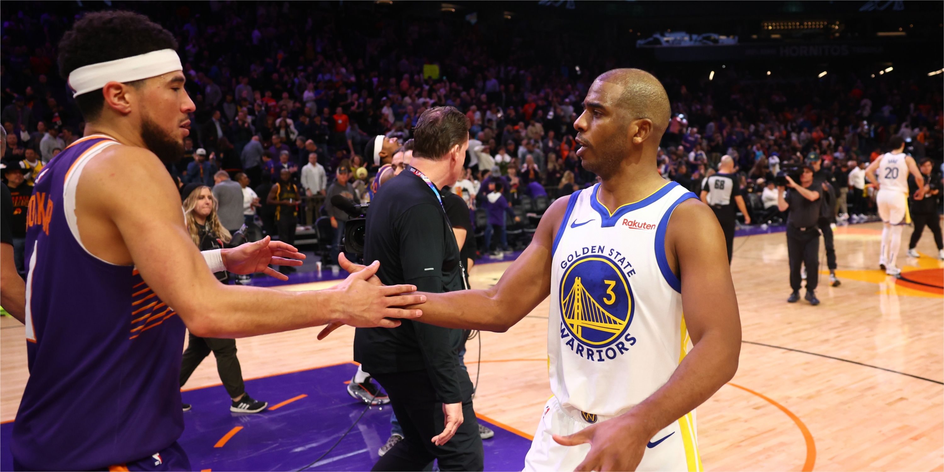 Warriors guard Chris Paul greets Suns guard Devin Booker