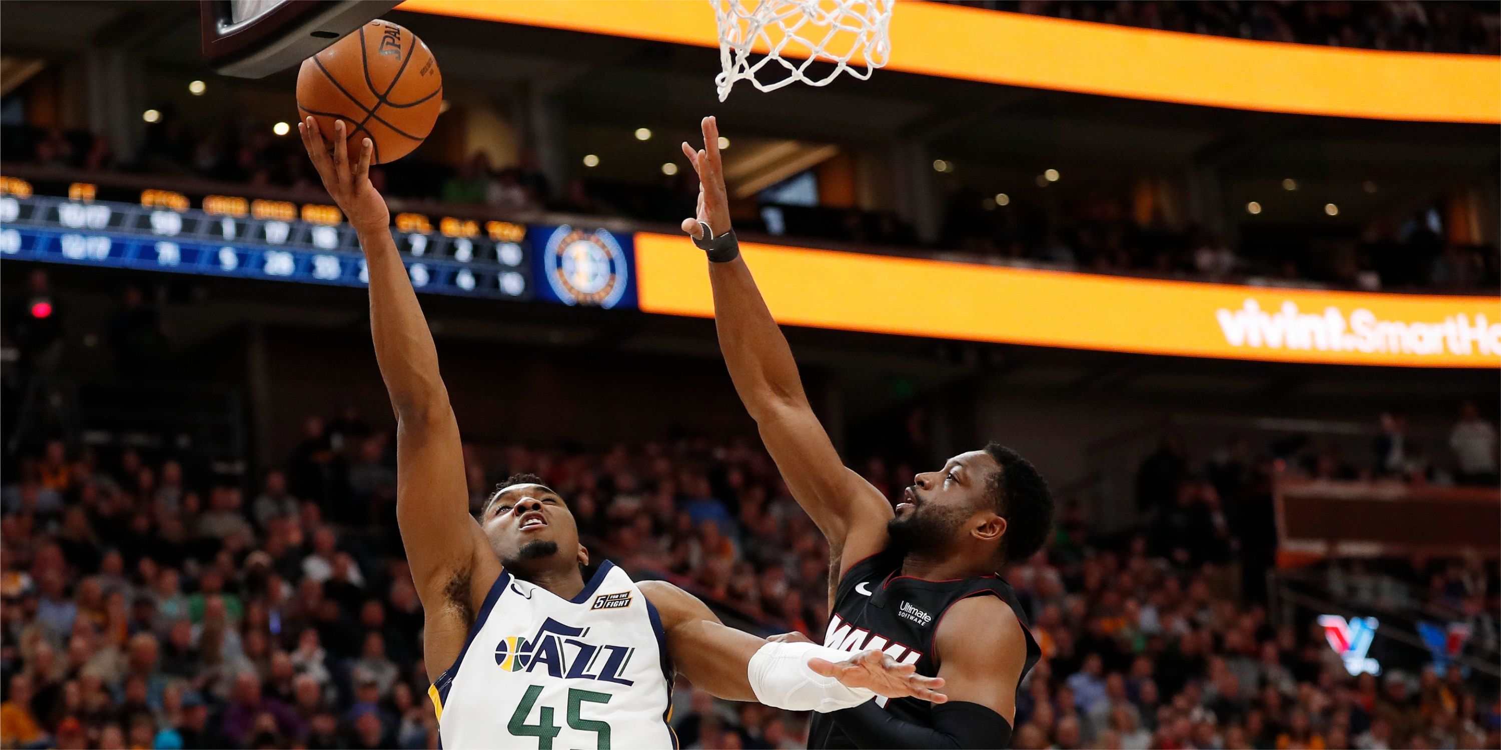 Heat guard Dwyane Wade attempts to block Jazz guard Donovan Mitchell