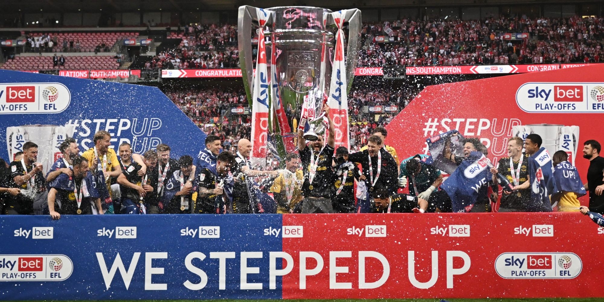 Southampton's Jack Stephens lifts the trophy with the team after winning the Championship Play-Off final