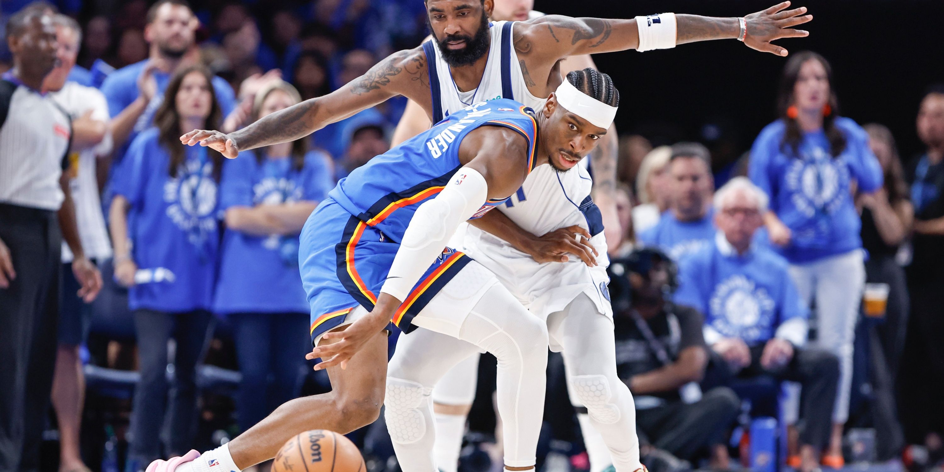 Shai Gilgeous-Alexander loses the ball while being defended by Kyrie Irving