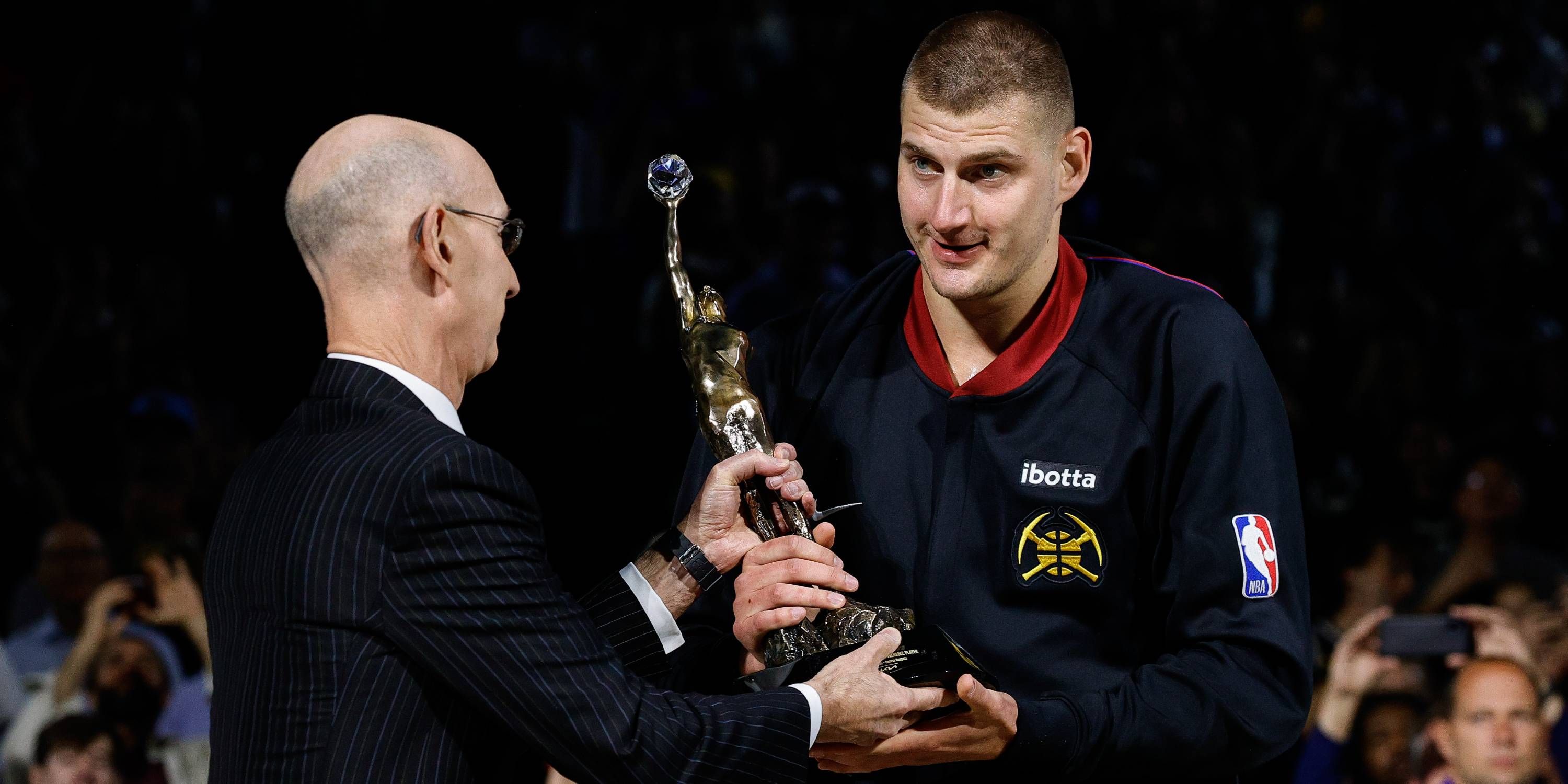 Nikola Jokic accepts the MVP award from Adam Silver.