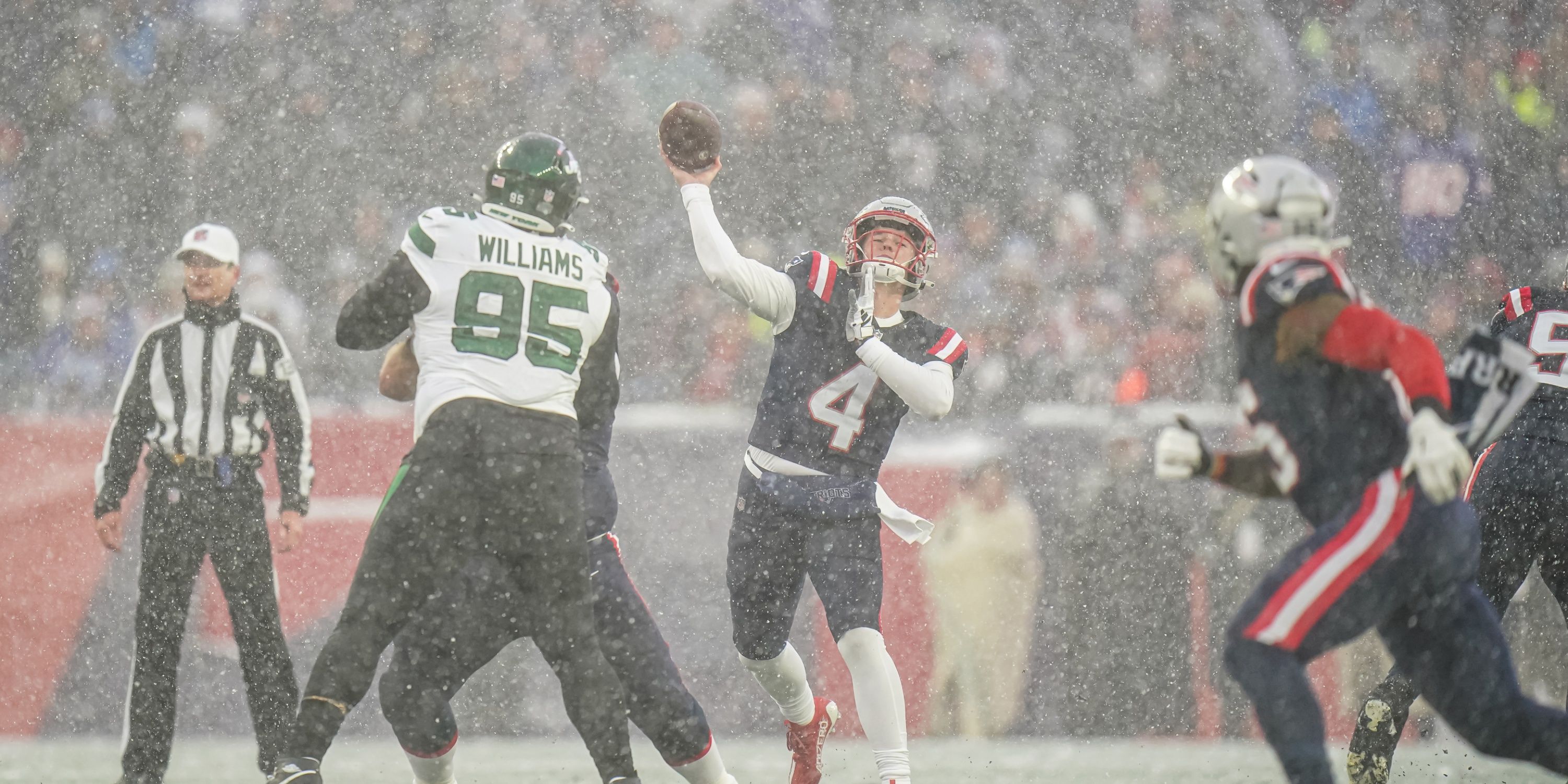 Bailey Zappe throwing into the snow at Gilette Stadium.