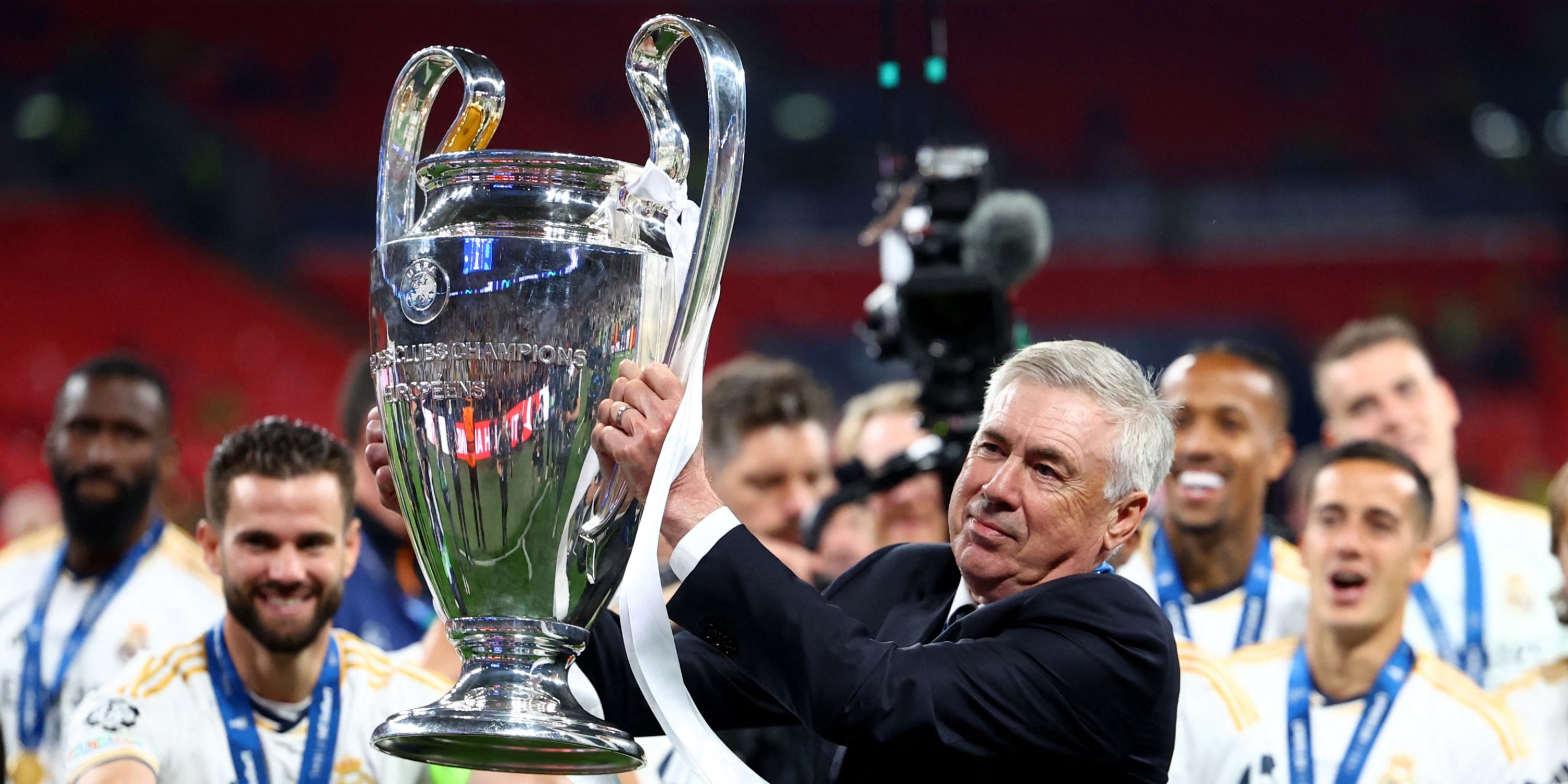 Carlo Ancelotti hoisting the Champions League trophy aloft