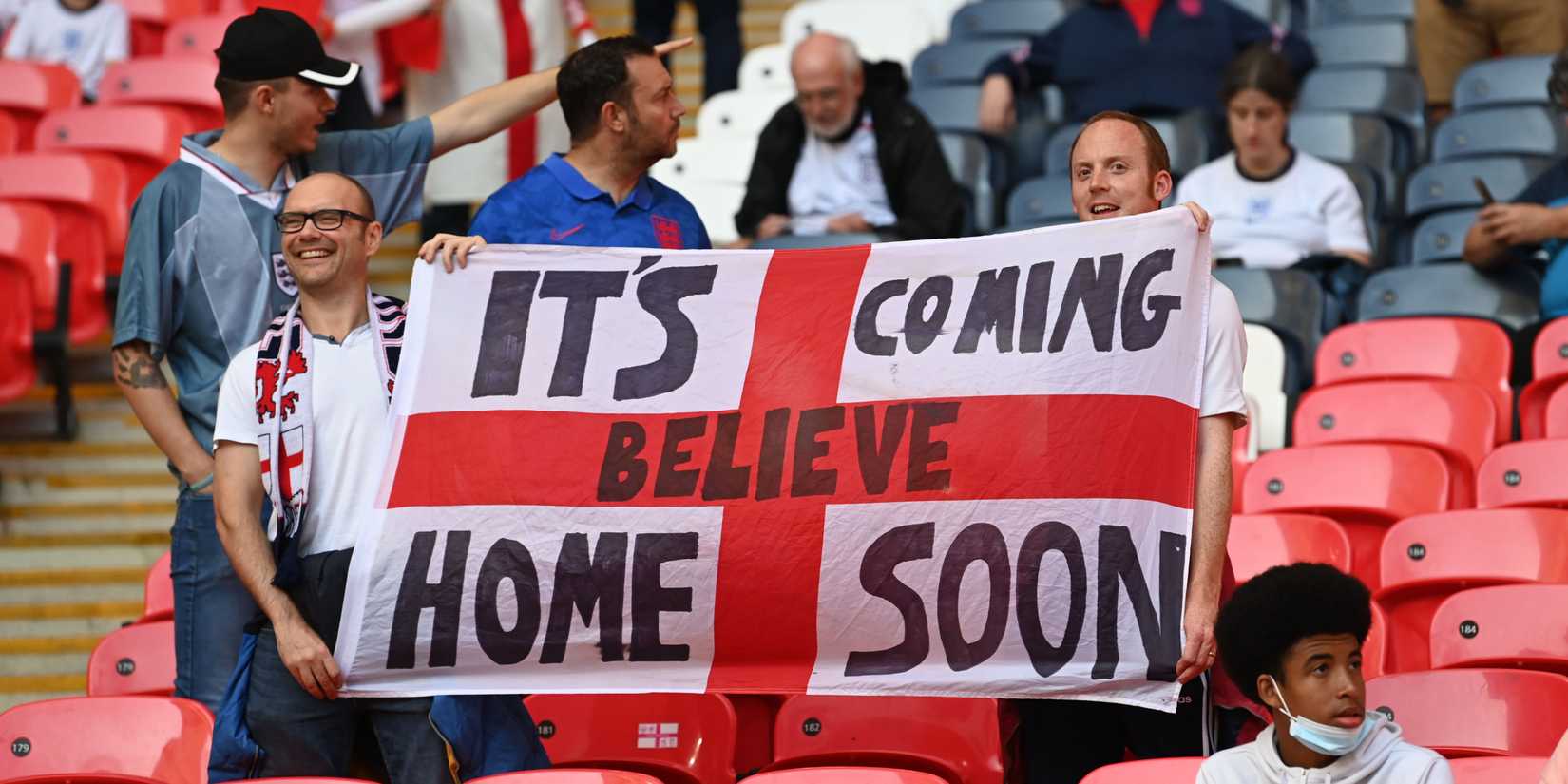 England fans holding a flag which reads: It's Coming Home Soon