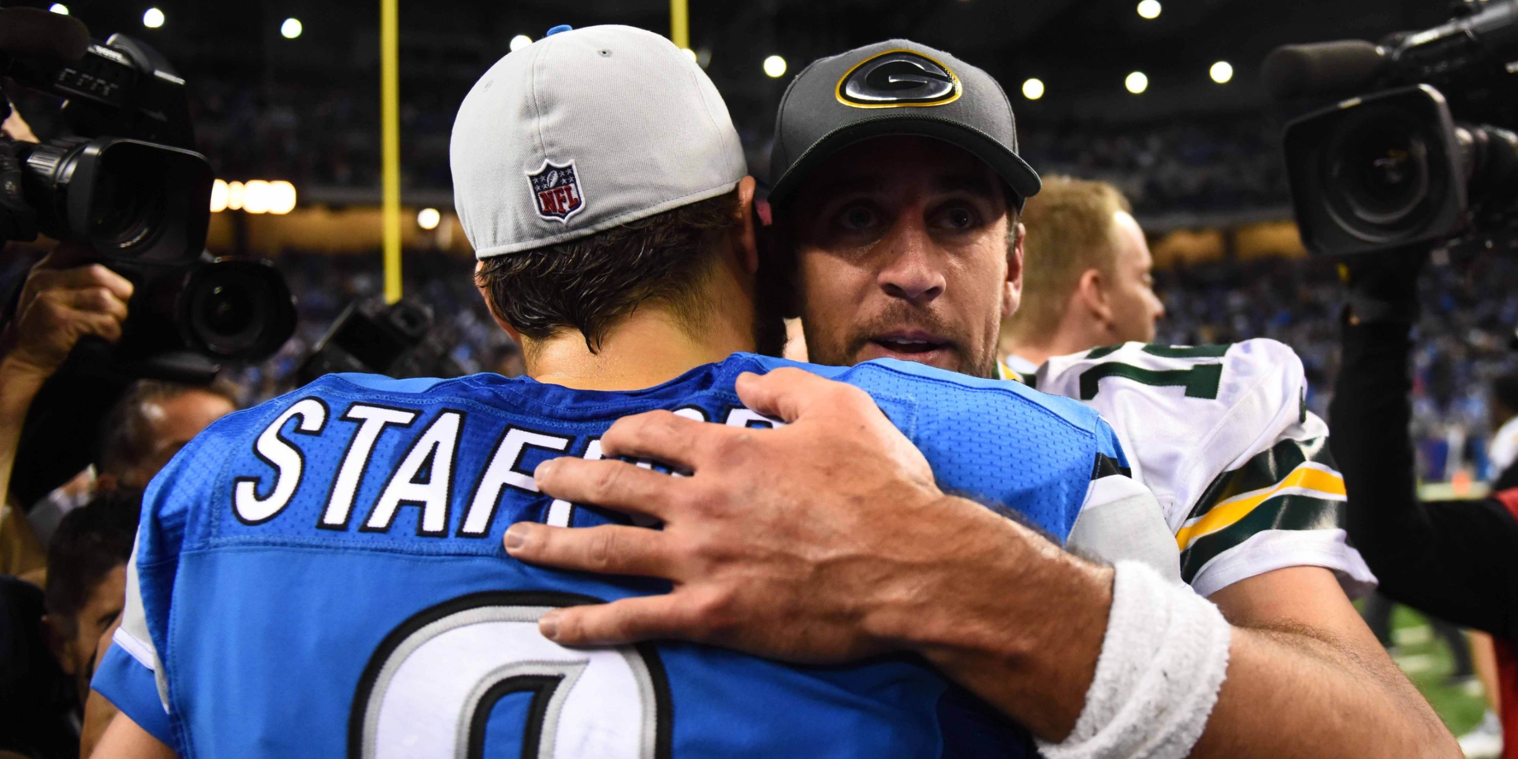 Detroit Lions QB Matthew Stafford and Green Bay Packers QB Aaron Rodgers embrace post-game