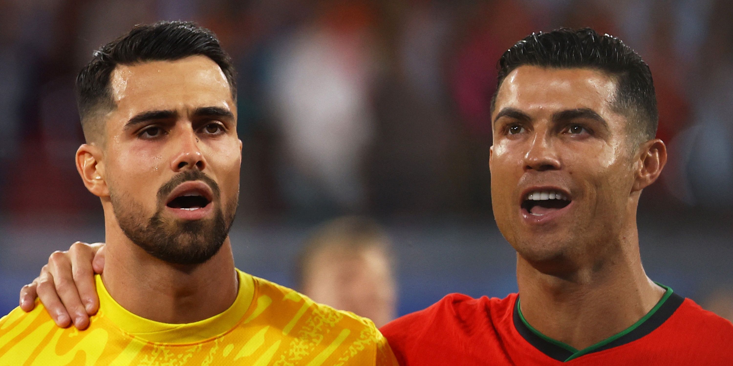Portugal's Cristiano Ronaldo and Diogo Costa line up during the national anthem