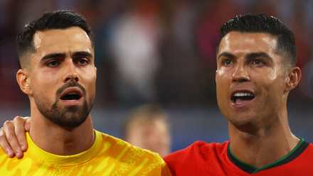 Portugal's Cristiano Ronaldo and Diogo Costa line up during the national anthem