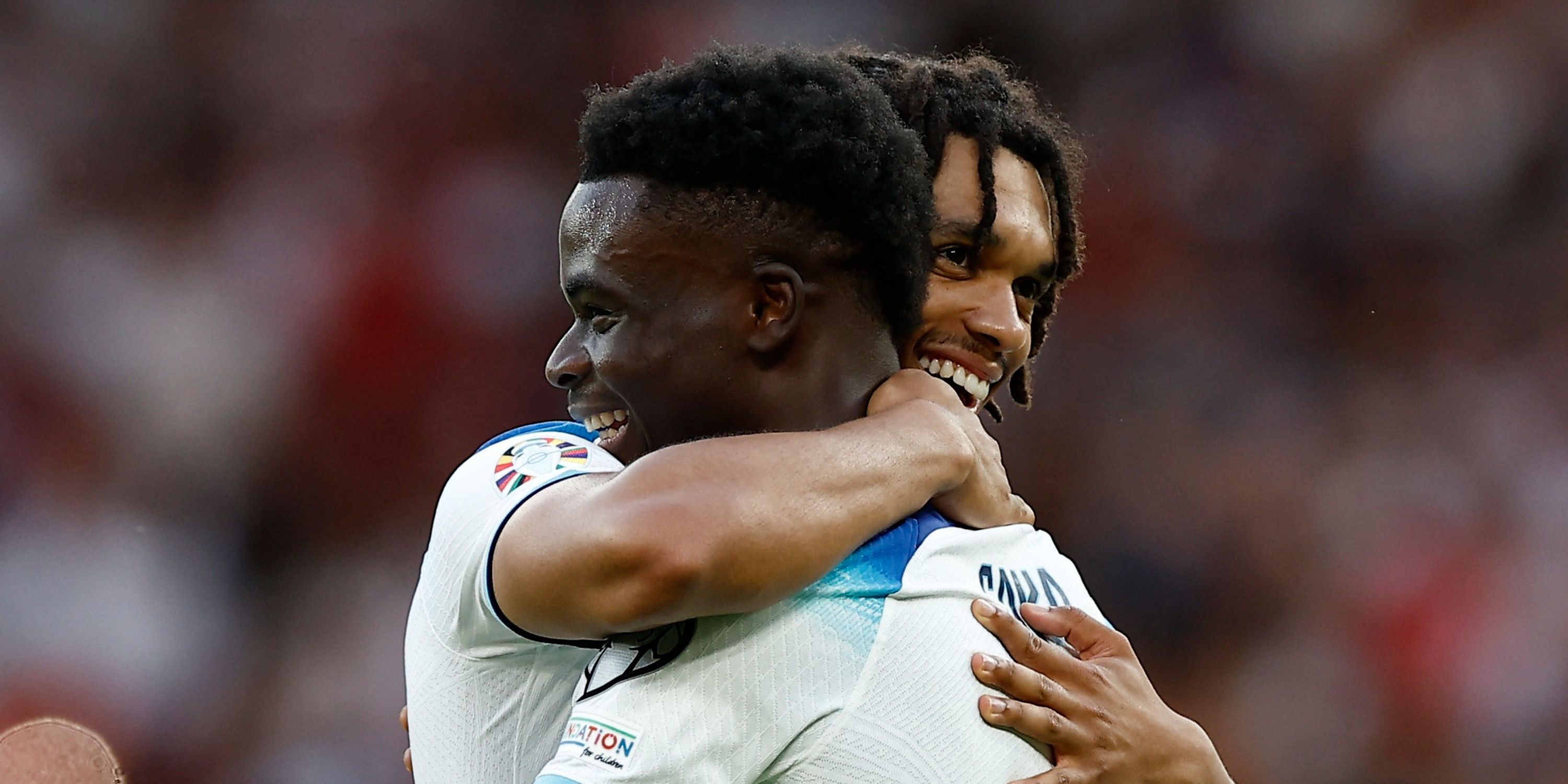 Trent Alexander-Arnold and Bukayo Saka hugging for England