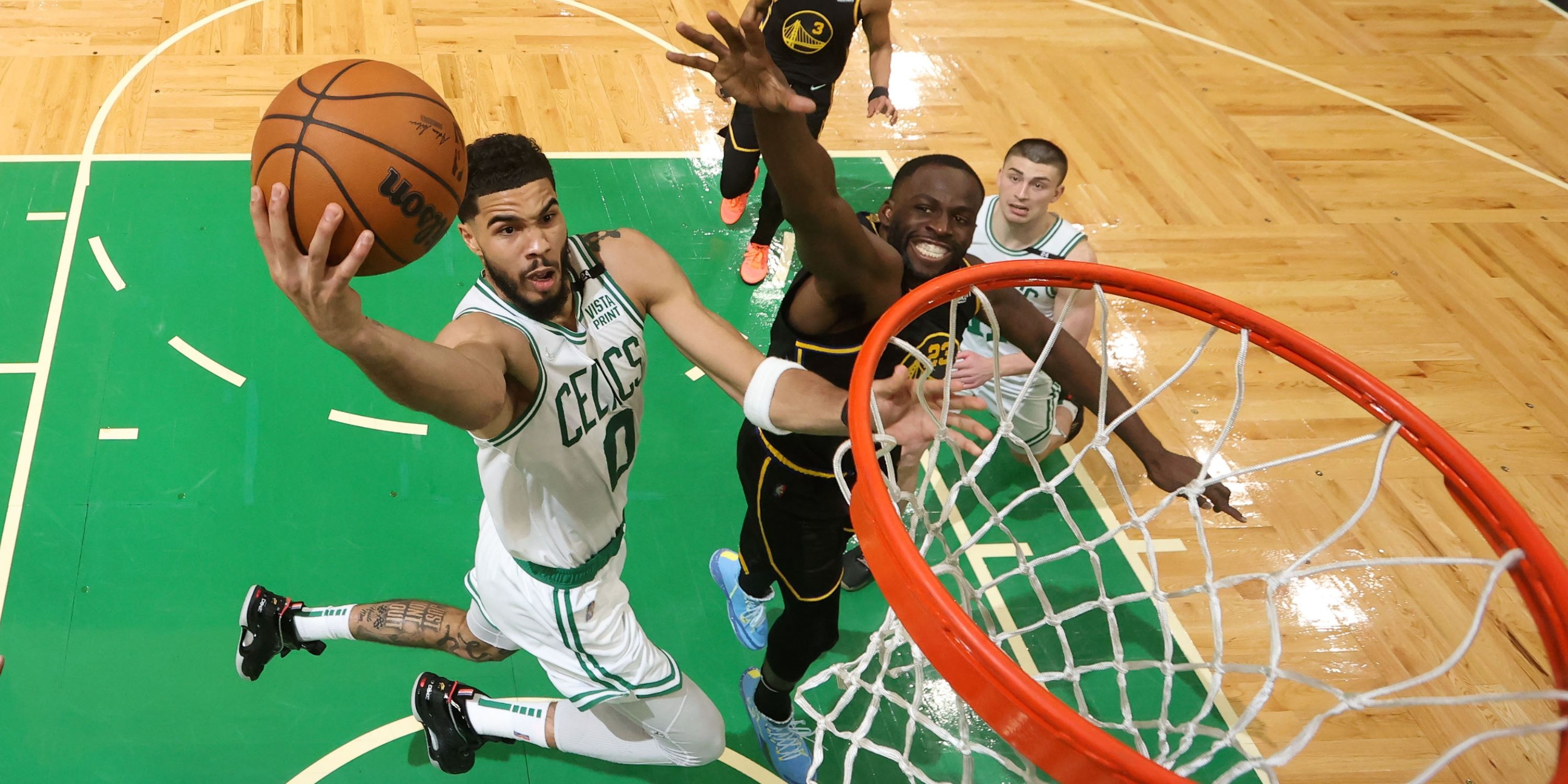 Boston Celtics' Jayson Tatum and Golden State Warriors' Draymond Green competing during the 2022 NBA Finals.