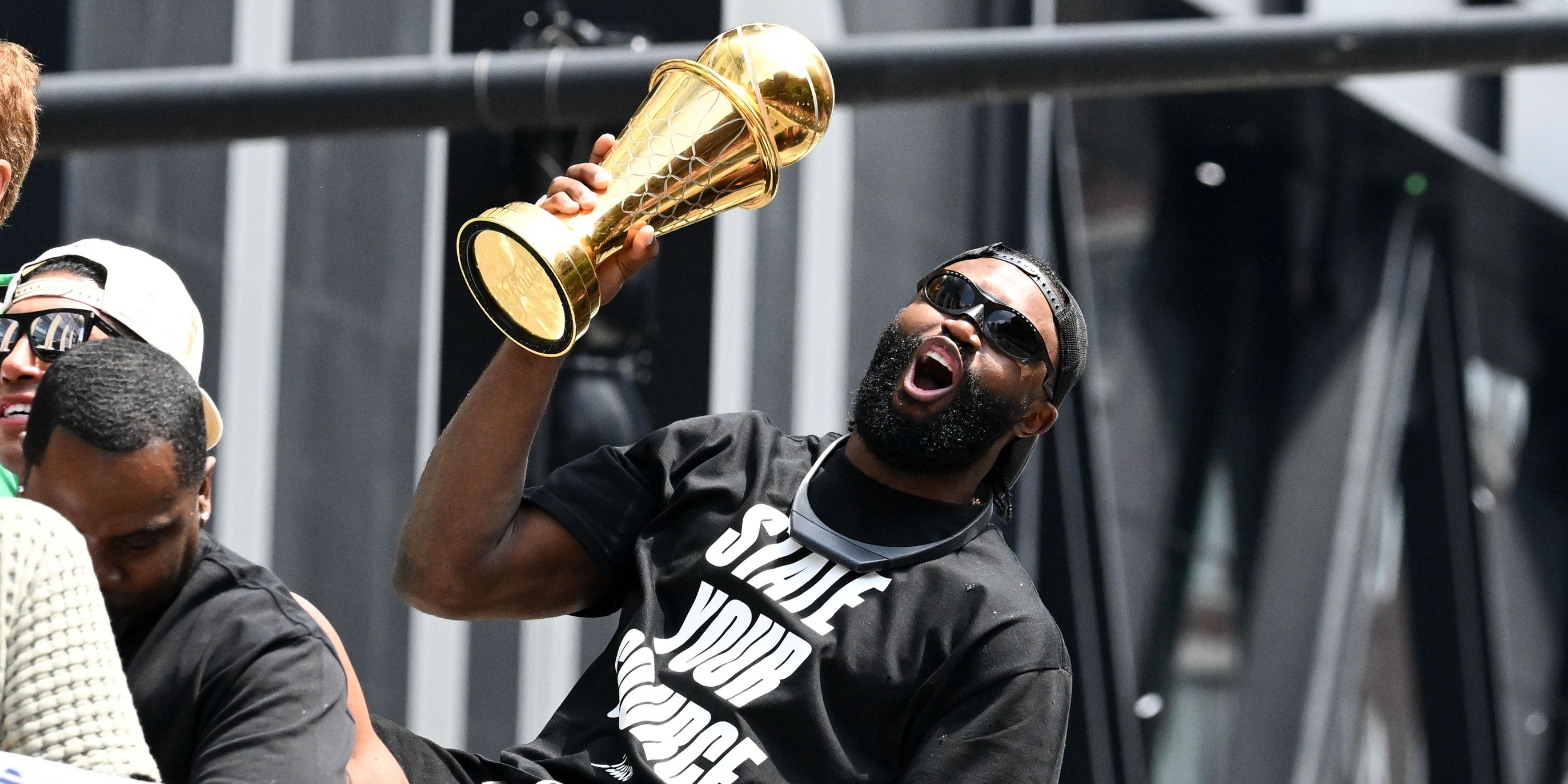 Celtics Jaylen Brown holding his Finals MVP trophy