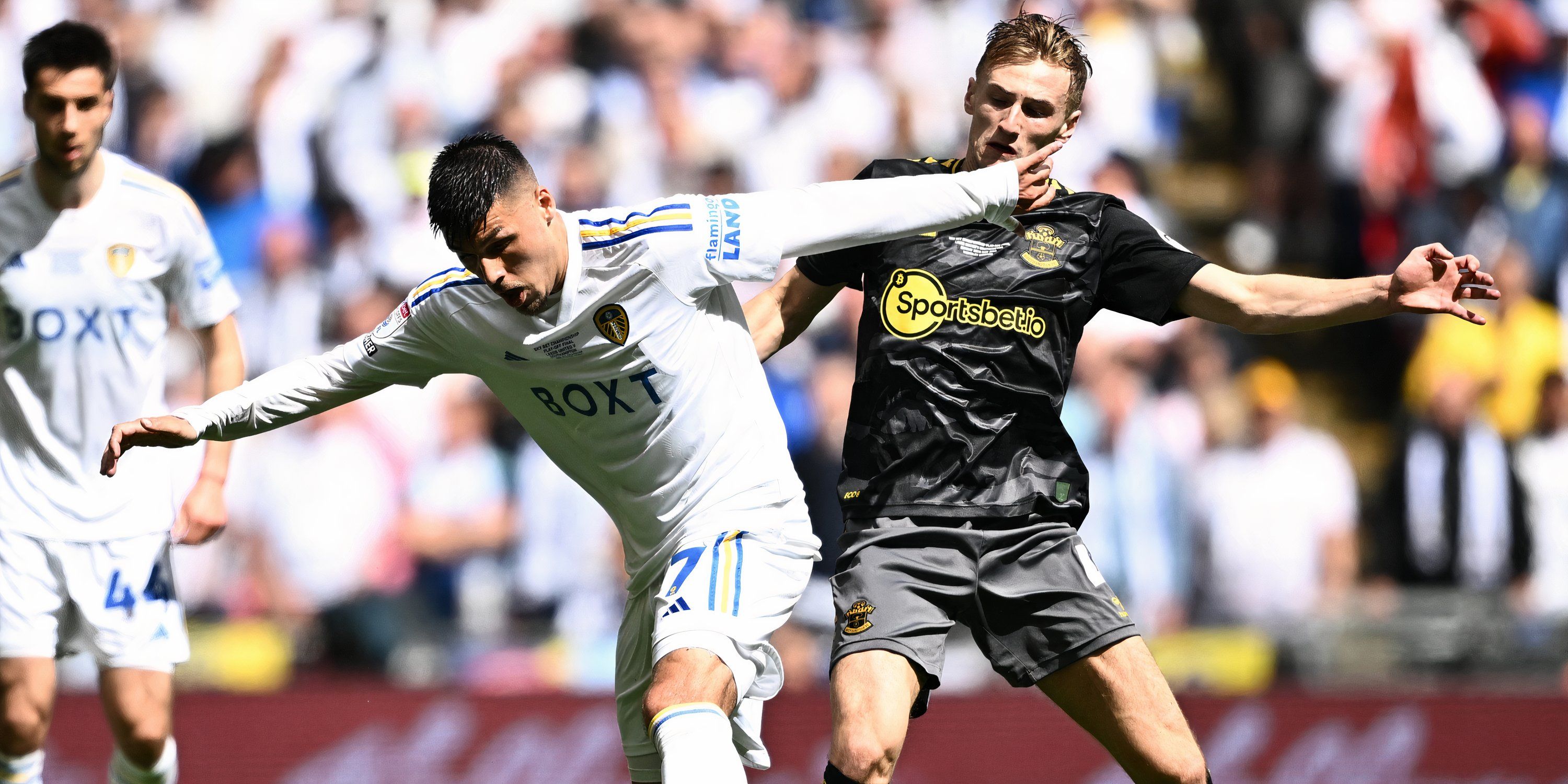 Southampton midfielder Flynn Downes battling with Leeds United striker Joel Piroe for possession