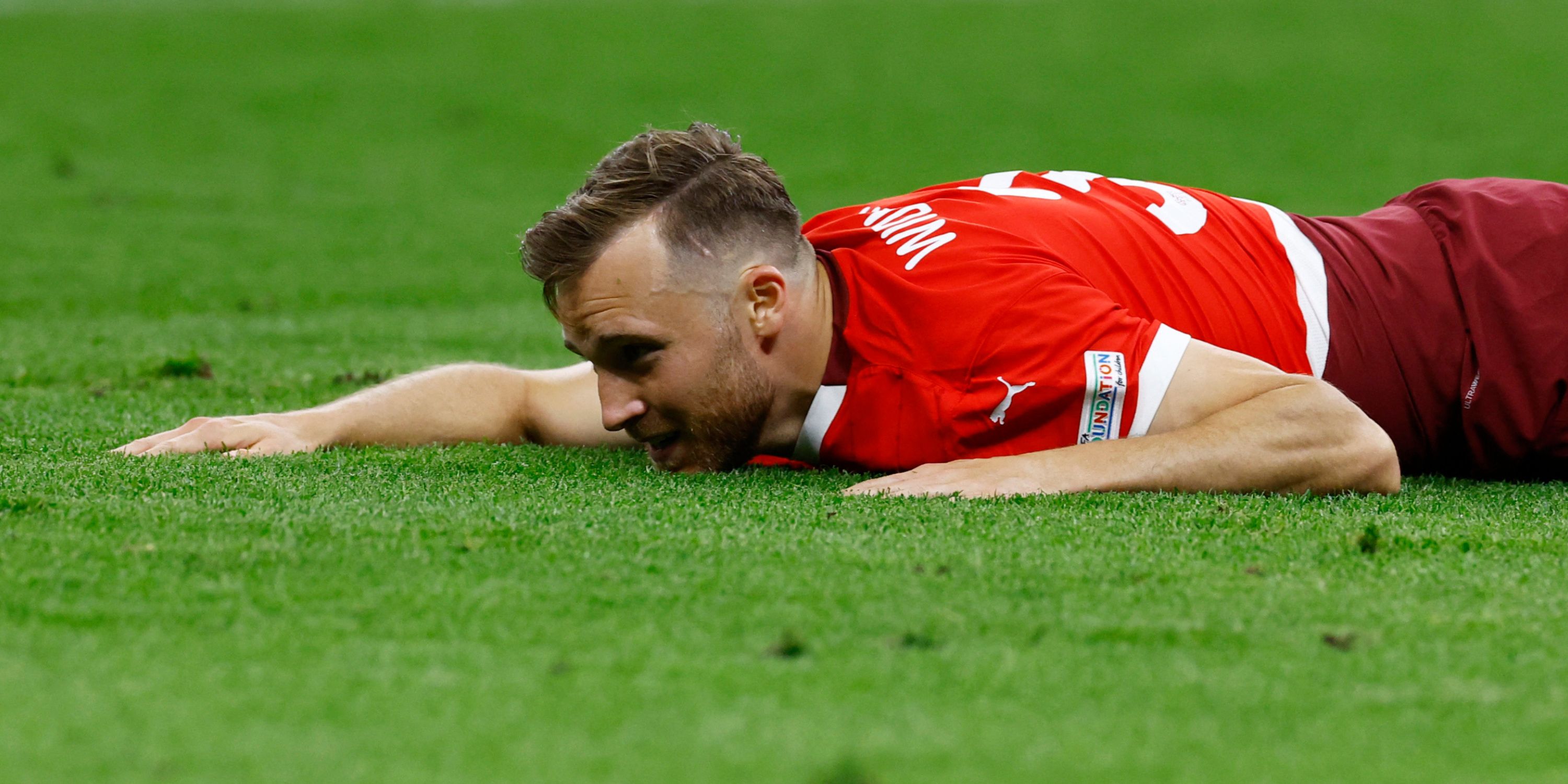 Silvan Widmer lying on the pitch at Euro 2024