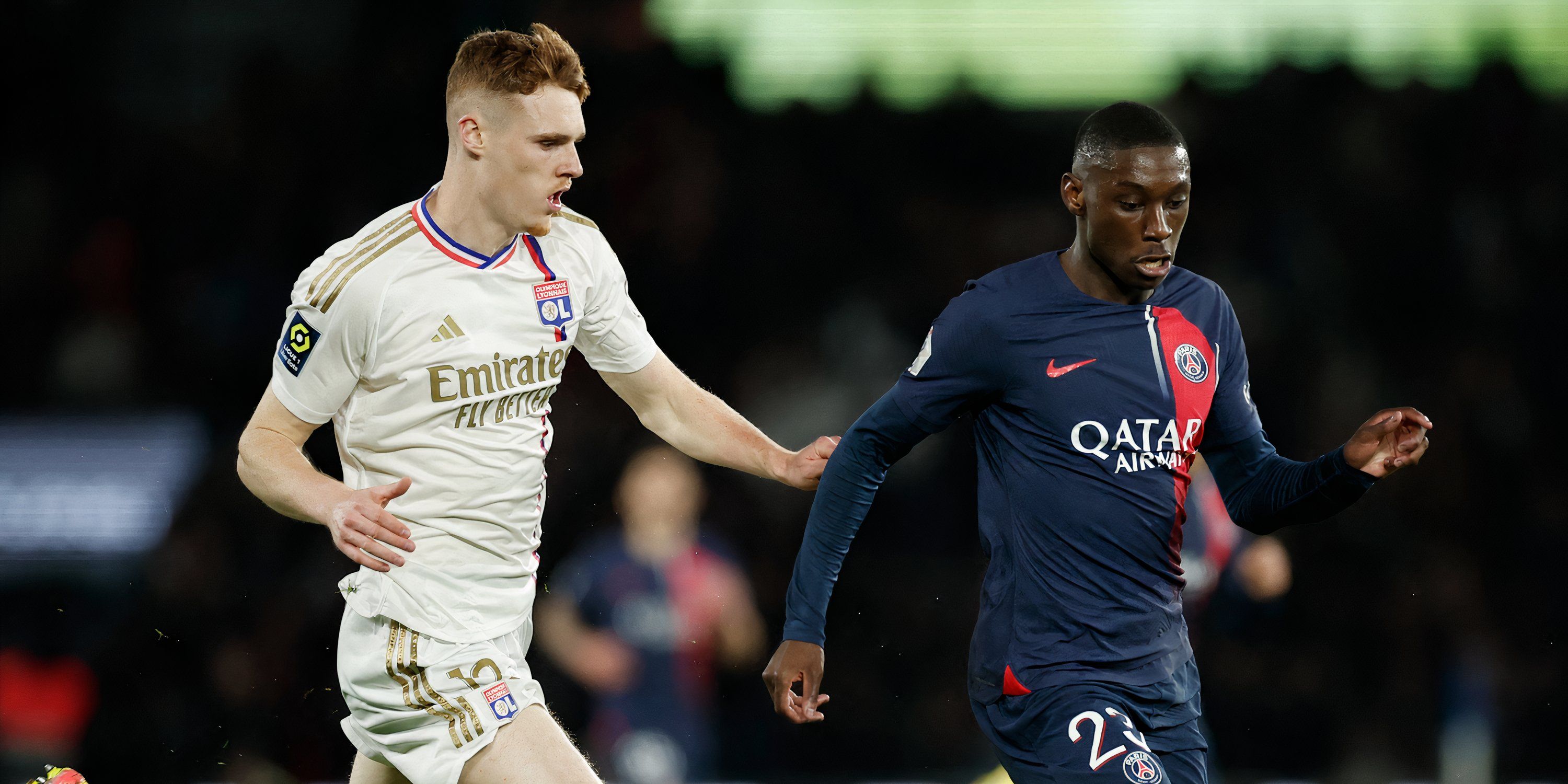 Lyon defender Jake O'Brien and Paris Saint-Germain attacker Randal Kolo Muani battling for possession