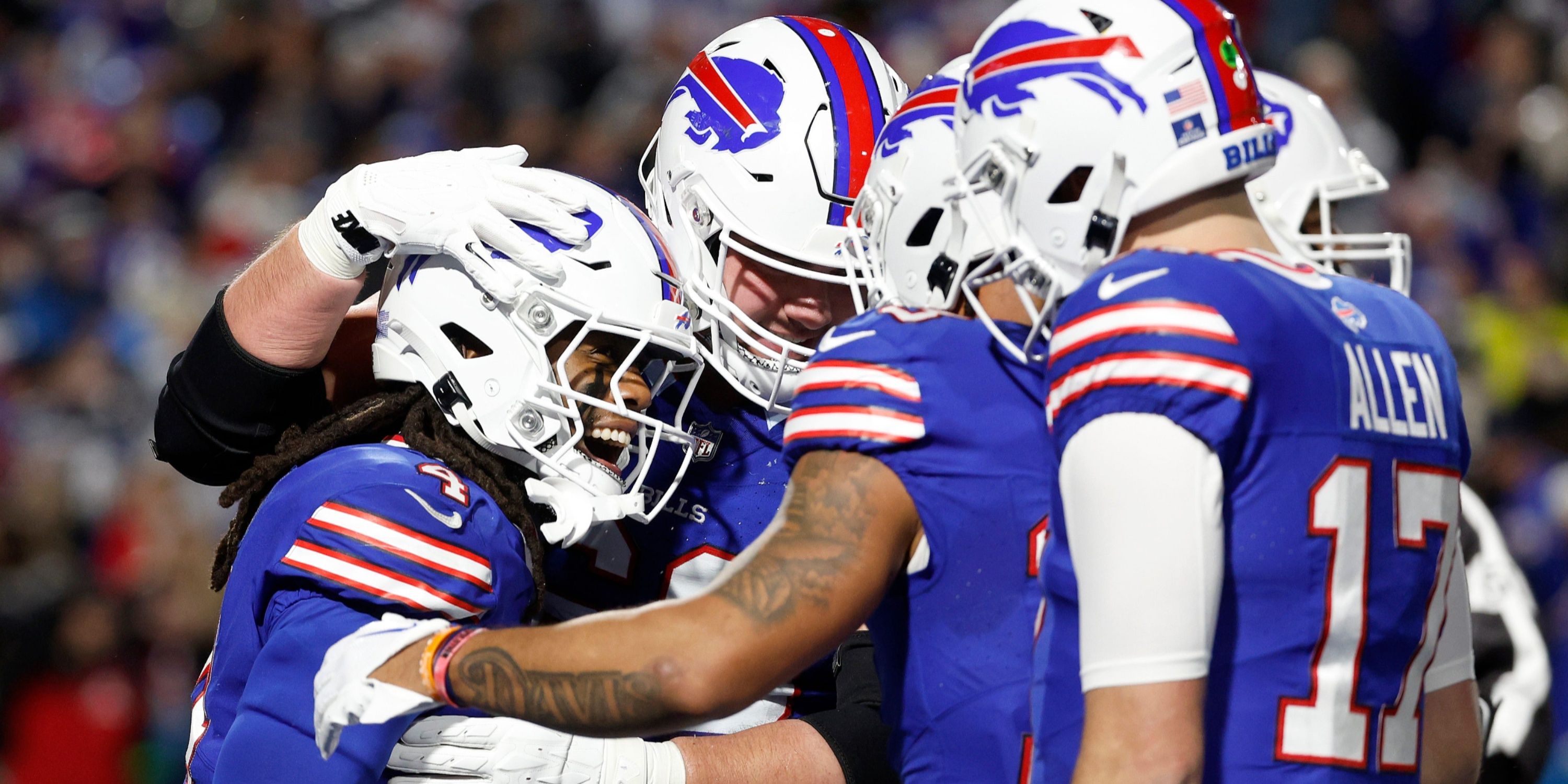 Buffalo Bills RB James Cook and QB Josh Allen celebrate with the team