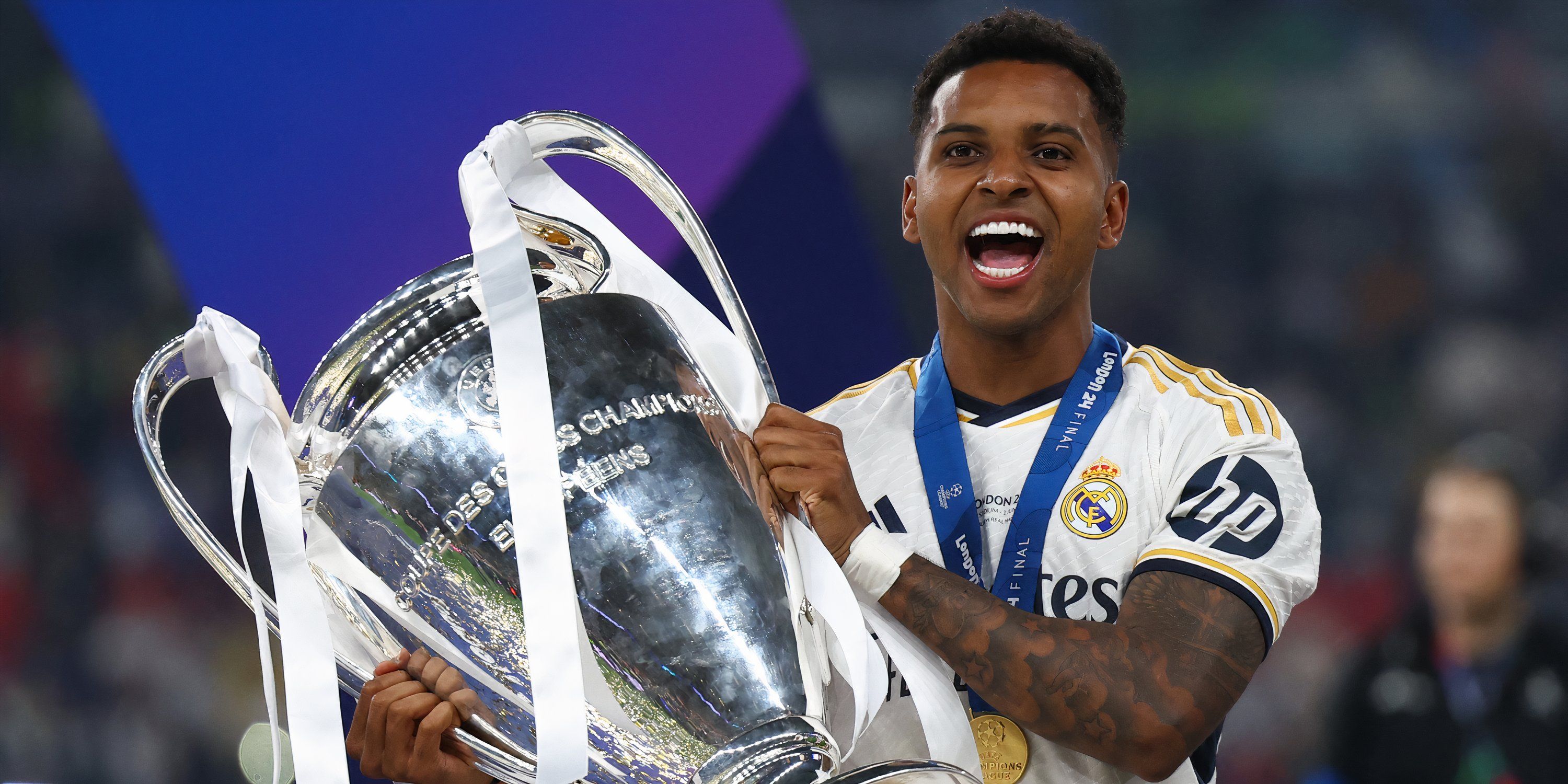 Real Madrid attacker Rodrygo celebrating with the Champions League trophy