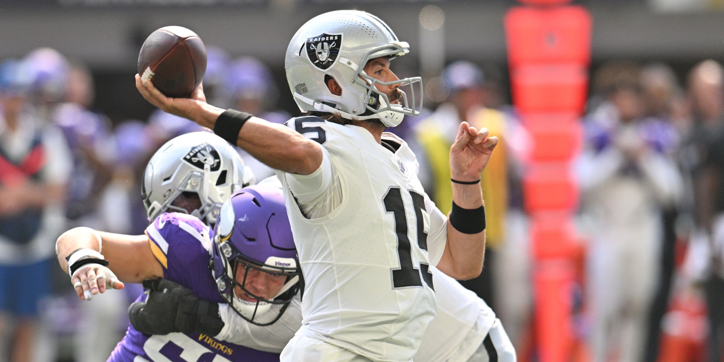  Las Vegas Raiders quarterback Gardner Minshew (15) throws a pass as Minnesota Vikings linebacker Owen Porter (57) pursues and offensive tackle Thayer Munford Jr. (rear) blocks during the second quarter at U.S. Bank Stadium