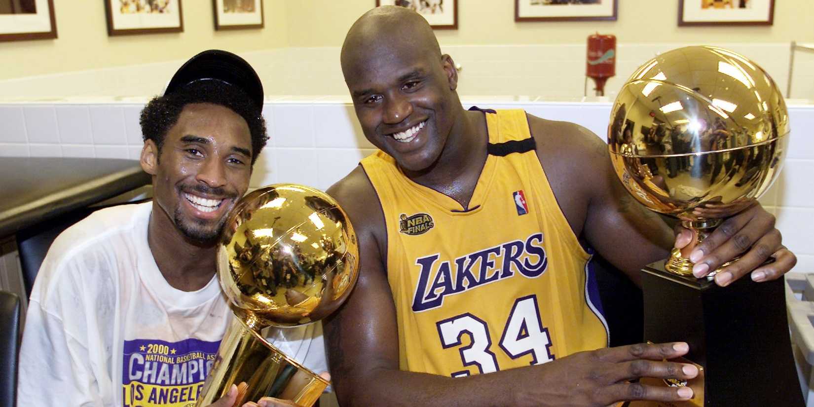 Kobe Bryant and Shaquille O'Neal of the Los Angeles Lakers hold NBA Finals trophys
