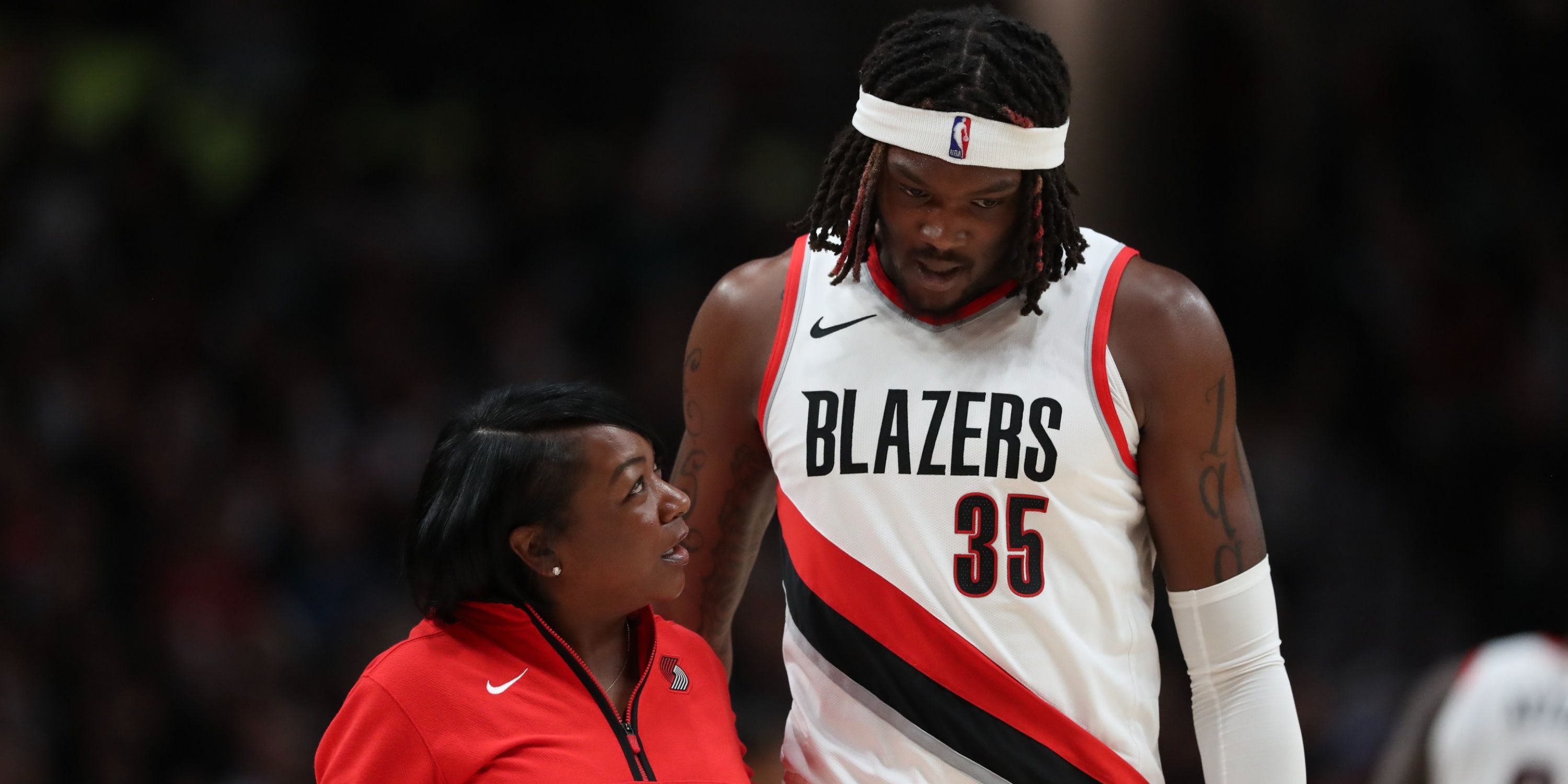 Portland Trail Blazers' Robert Williams III leaves the court after being injured.