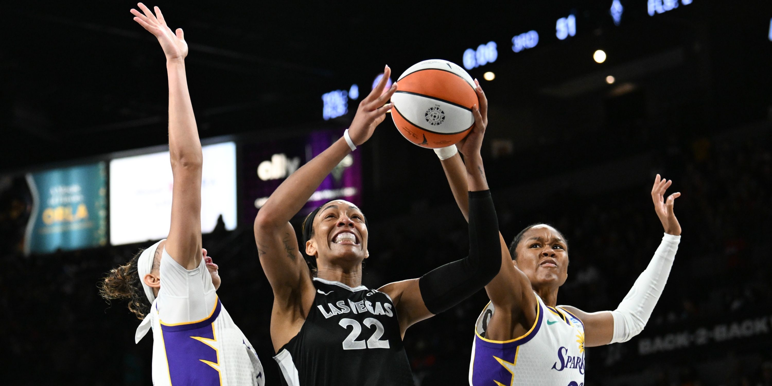 A'ja Wilson #22 of the Las Vegas Aces shoots against Dearica Hamby #5 and Azura Stevens #23 of the Los Angeles Sparks