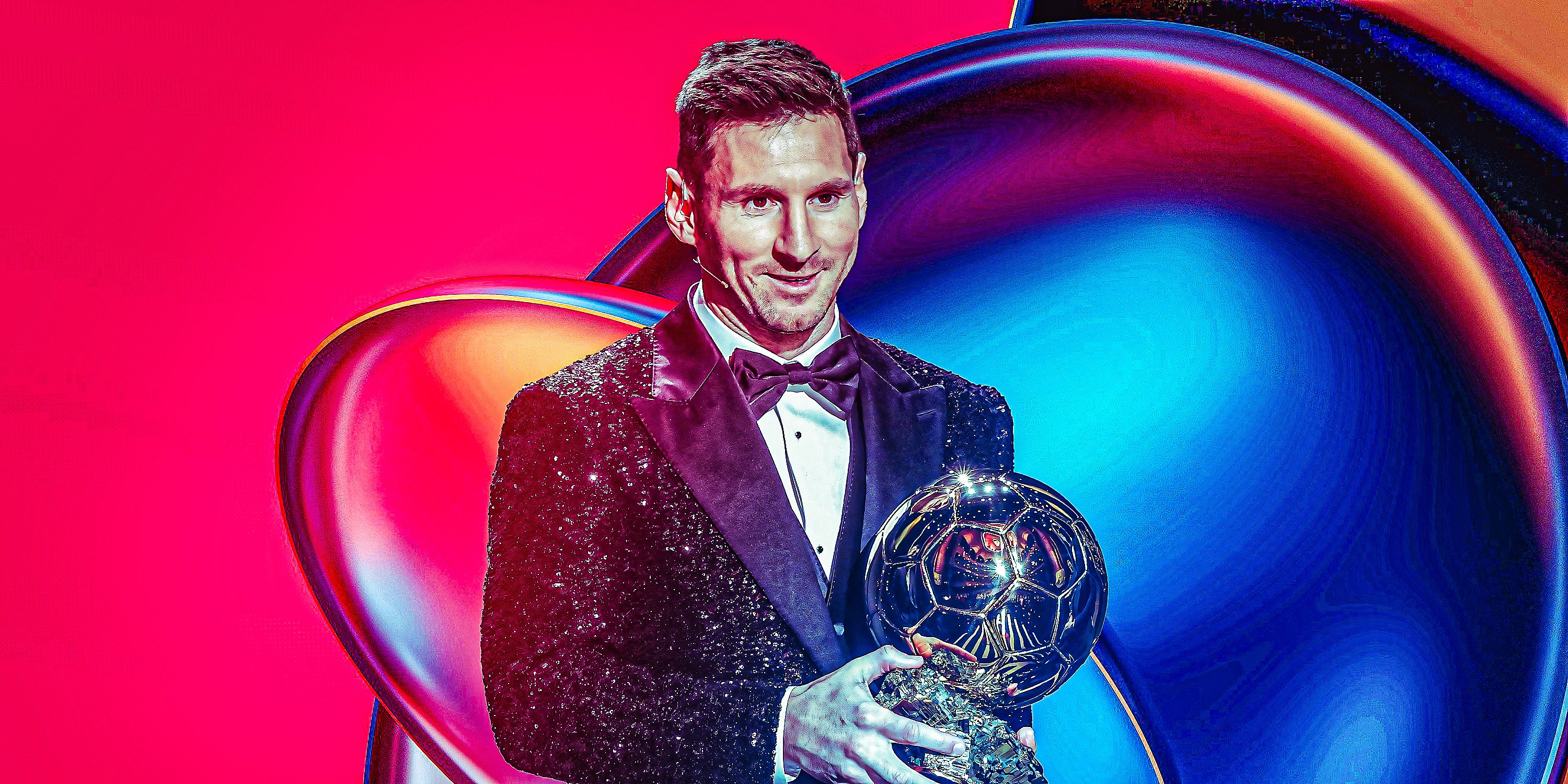 Lionel Messi standing on stage holding Ballon d'Or from 2021