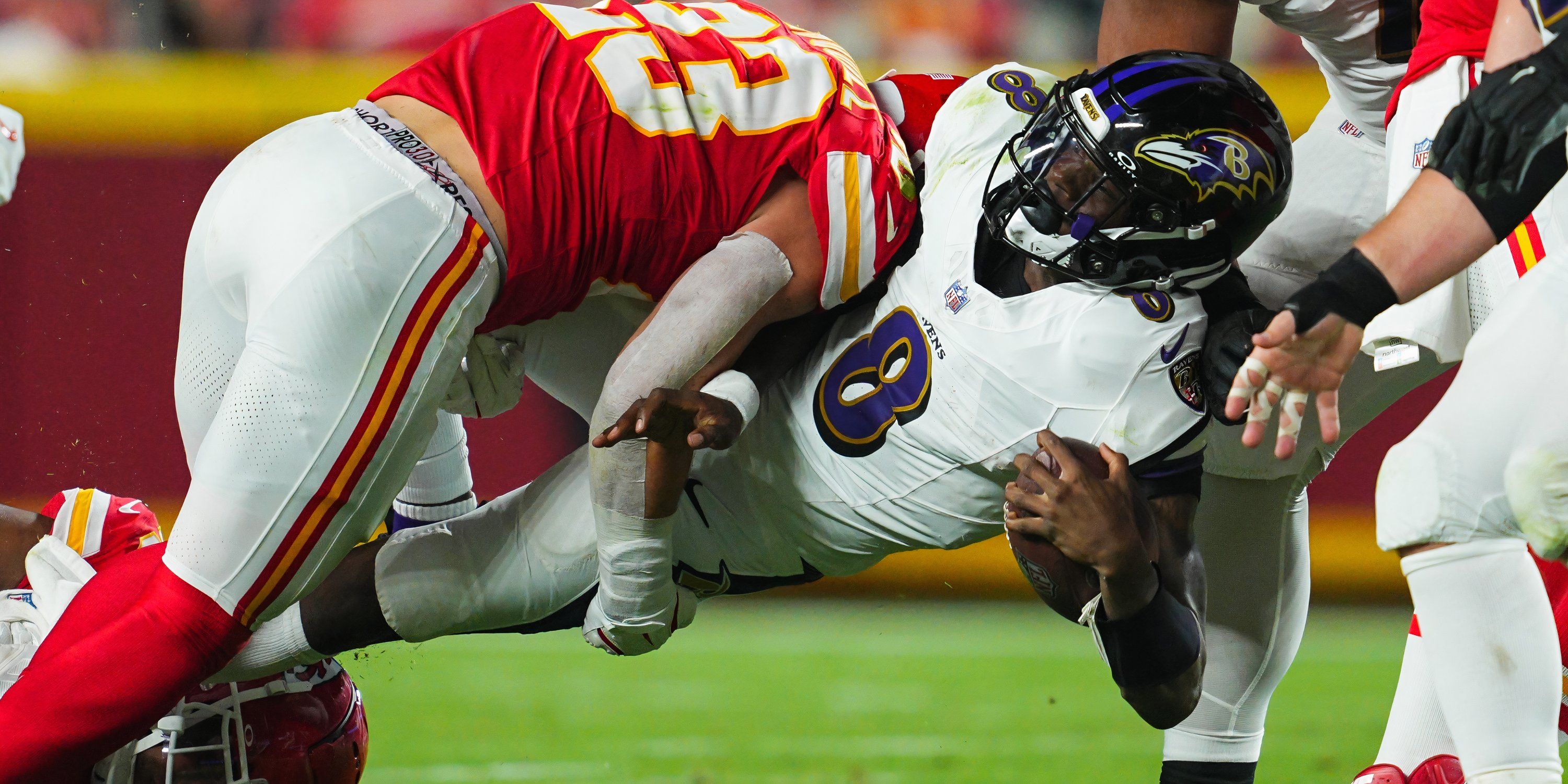 Baltimore Ravens quarterback Lamar Jackson (8) is tackled by Kansas City Chiefs linebacker Drue Tranquill (23) during the first half at GEHA Field at Arrowhead Stadium