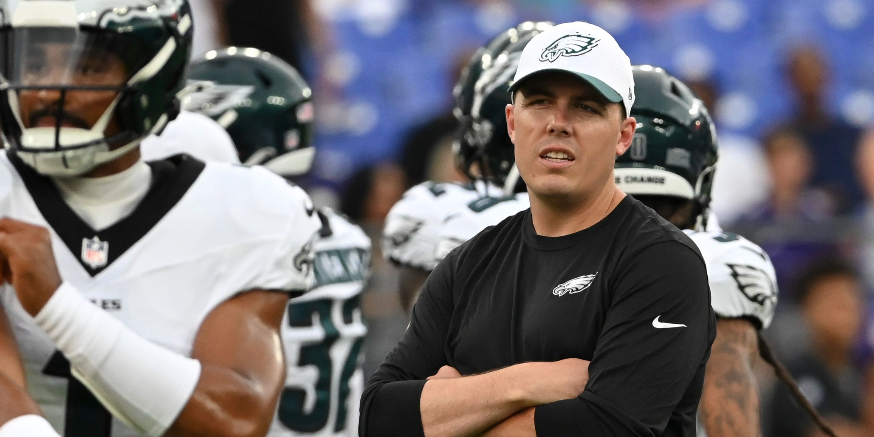 Eagles OC Kellen Moore watches Jalen Hurts warm up