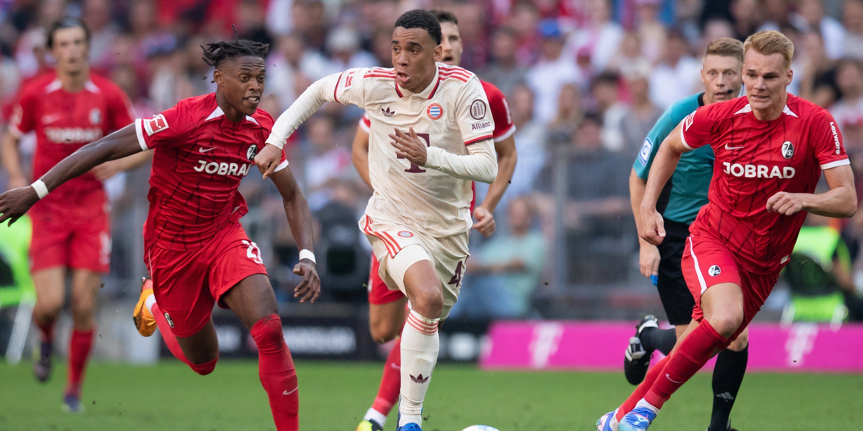 Bayern Munich attacking midfielder Jamal Musiala attempting to break away from the Freiburg defence