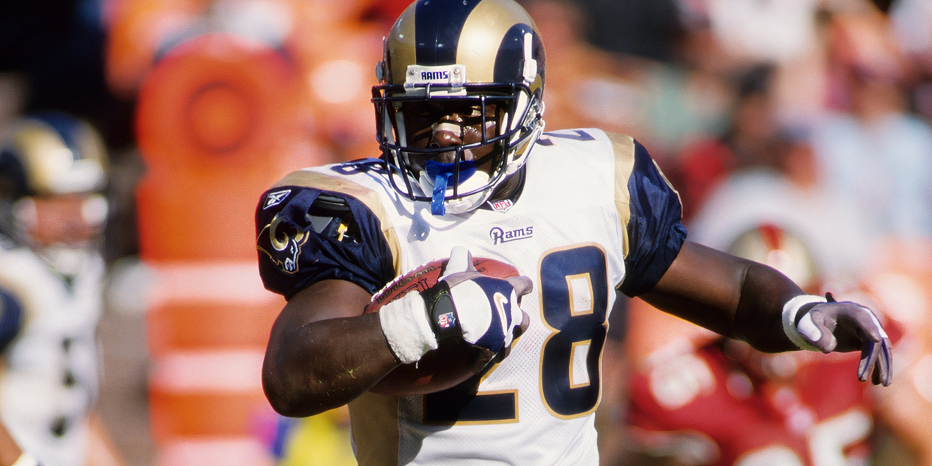 St. Louis Rams running back Marshall Faulk (28) carries the ball against the San Francisco 49ers at Candlestick Park.