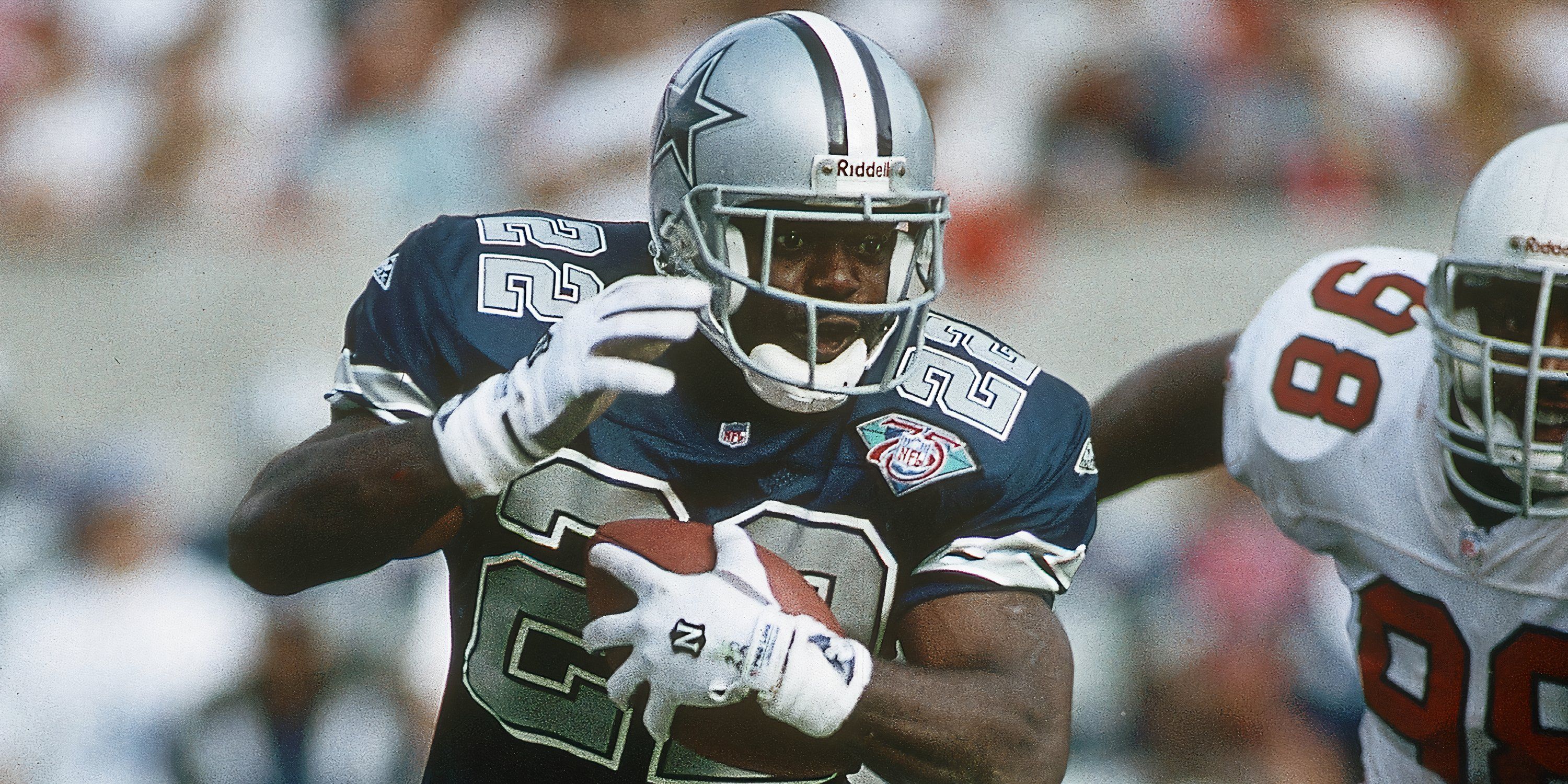 Dallas Cowboys running back Emmitt Smith (22) in action against Arizona Cardinals defensive tackle Eric Swann (98) at Sun Devil Stadium.