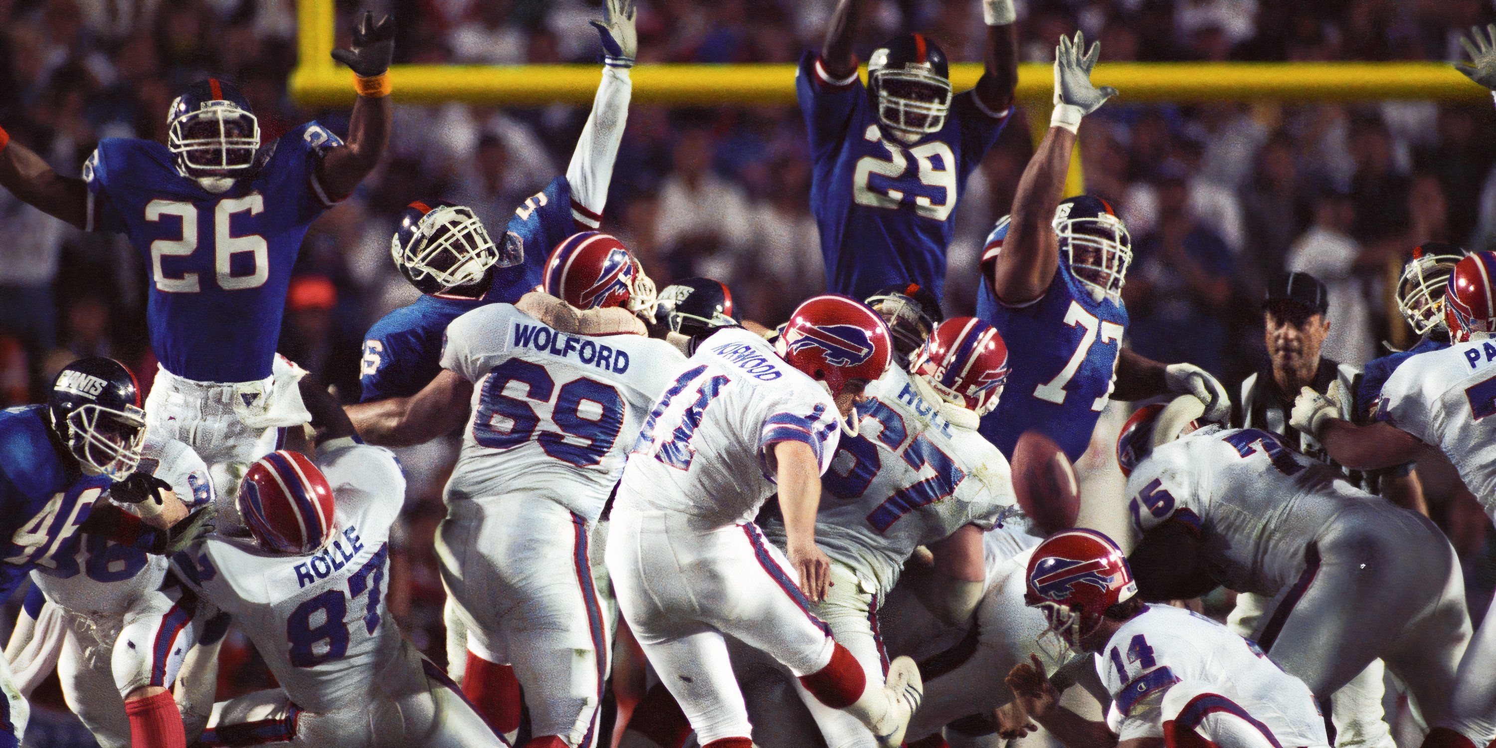 Buffalo Bills kicker Scott Norwood (11) attempts a field goal under the hold of quarterback Frank Reich (14) during Super Bowl XXV against the New York Giants at Tampa Stadium