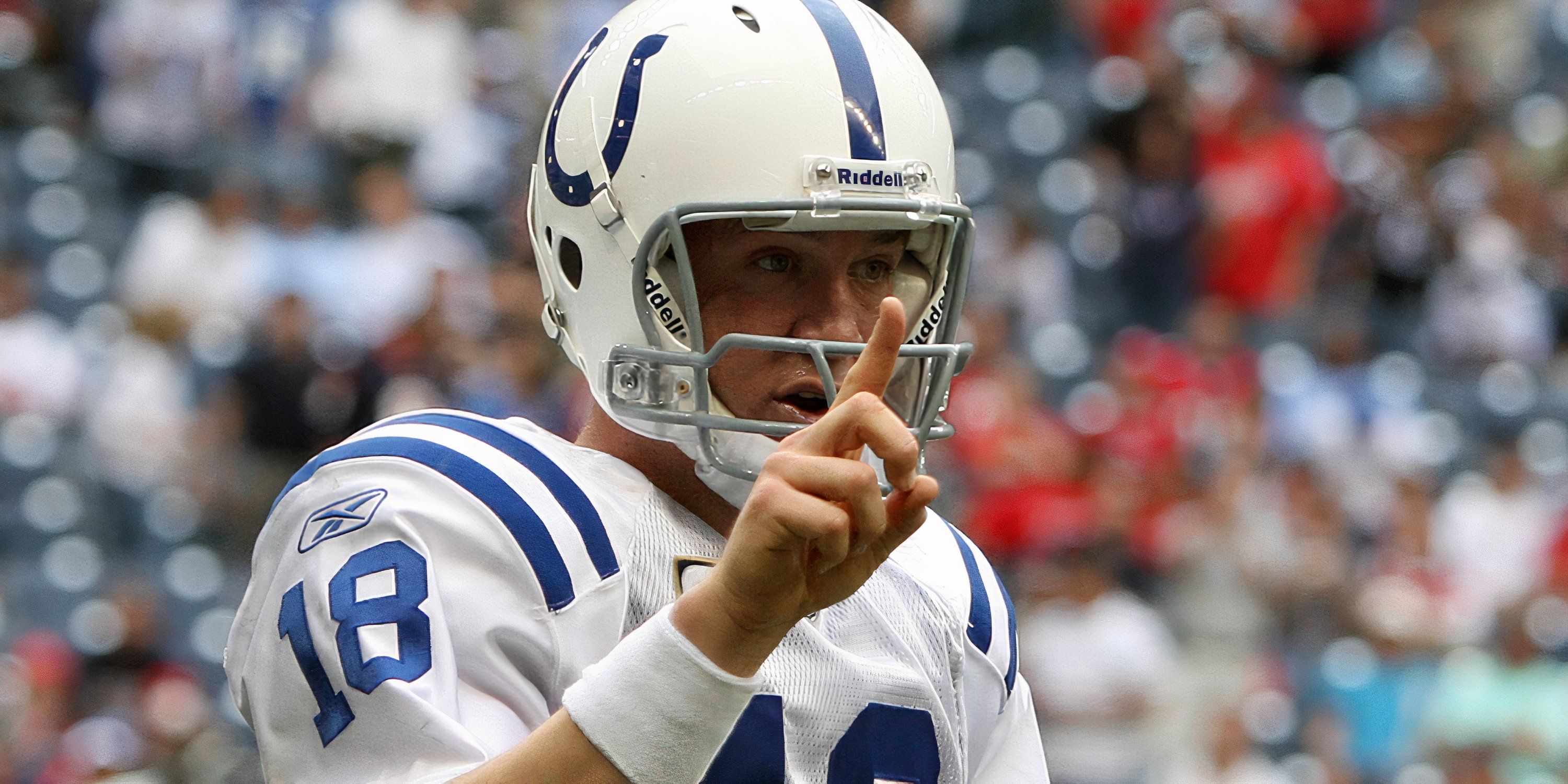 ndianapolis Colts quarterback Peyton Manning (18) signals to go for 1 after a fourth quarter touchdown against the Houston Texans at Reliant Stadium