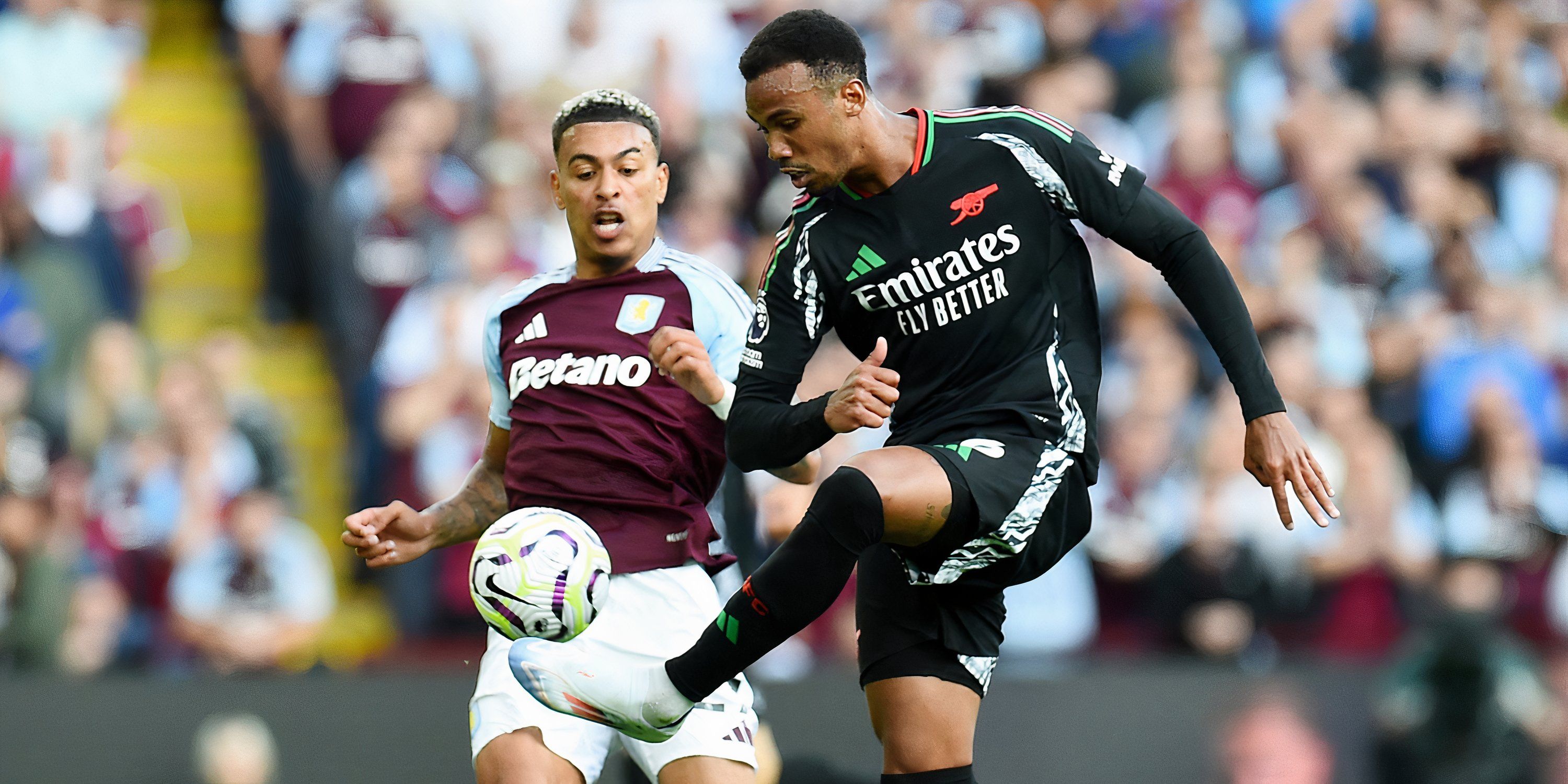 Arsenal defender Gabriel Magalhaes makes a clearance when under pressure from Aston Villa attacking midfielder Morgan Rogers