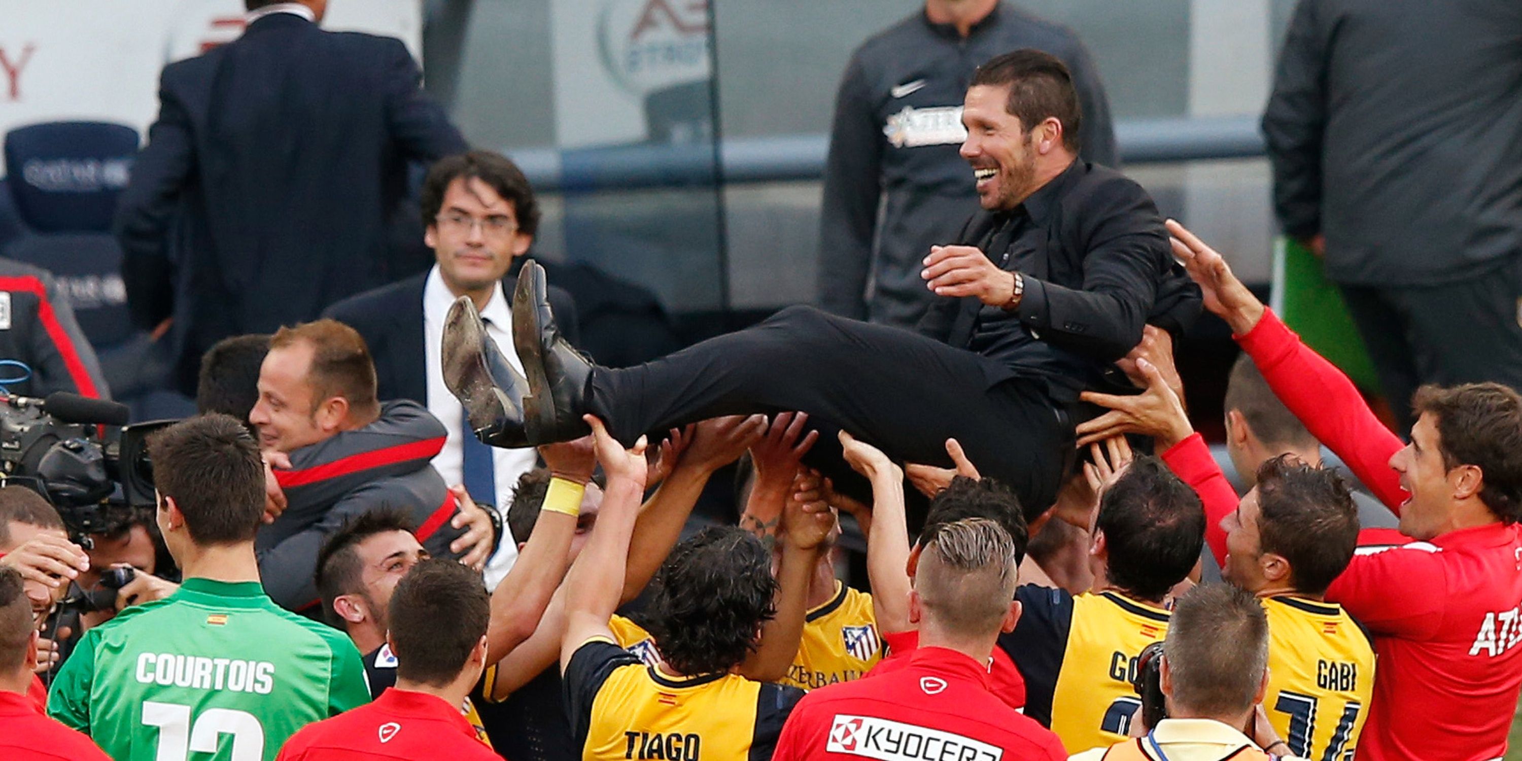 Simeone lifted in the air during the celebrations in 2014