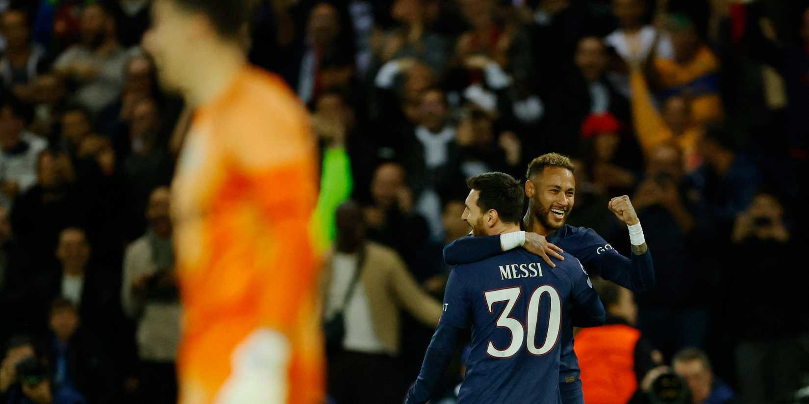 Paris St Germain's Neymar celebrates scoring their third goal with Lionel Messi