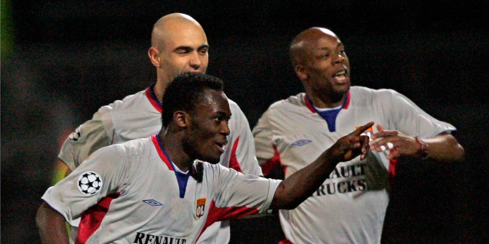 Olympique Lyon's Essien Cris and Wiltord celebrate after second goal against Werder Bremen in Champions League match in Lyon