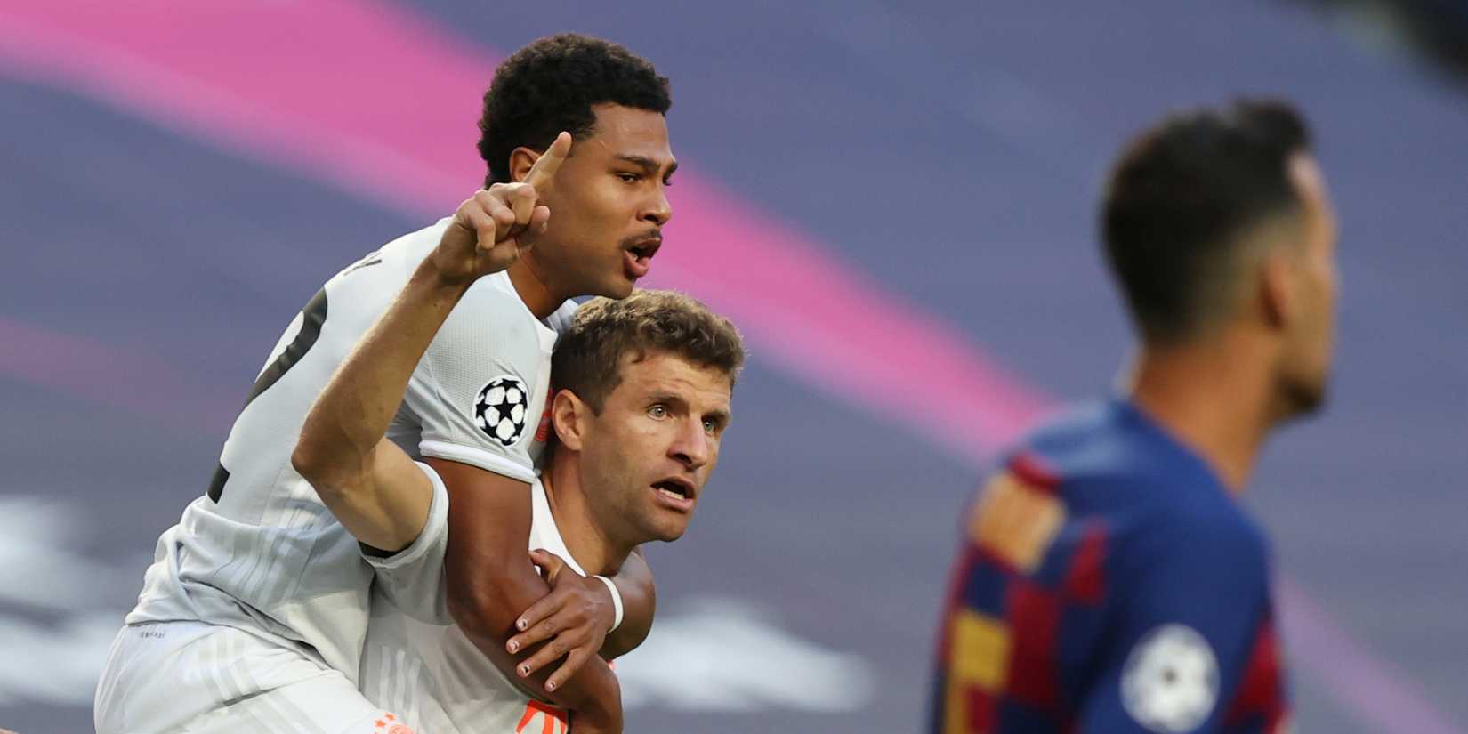 Bayern Munich's Thomas Muller celebrates scoring their first goal with Serge Gnabry, as play resumes behind closed doors following the outbreak of the coronavirus disease (COVID-19)