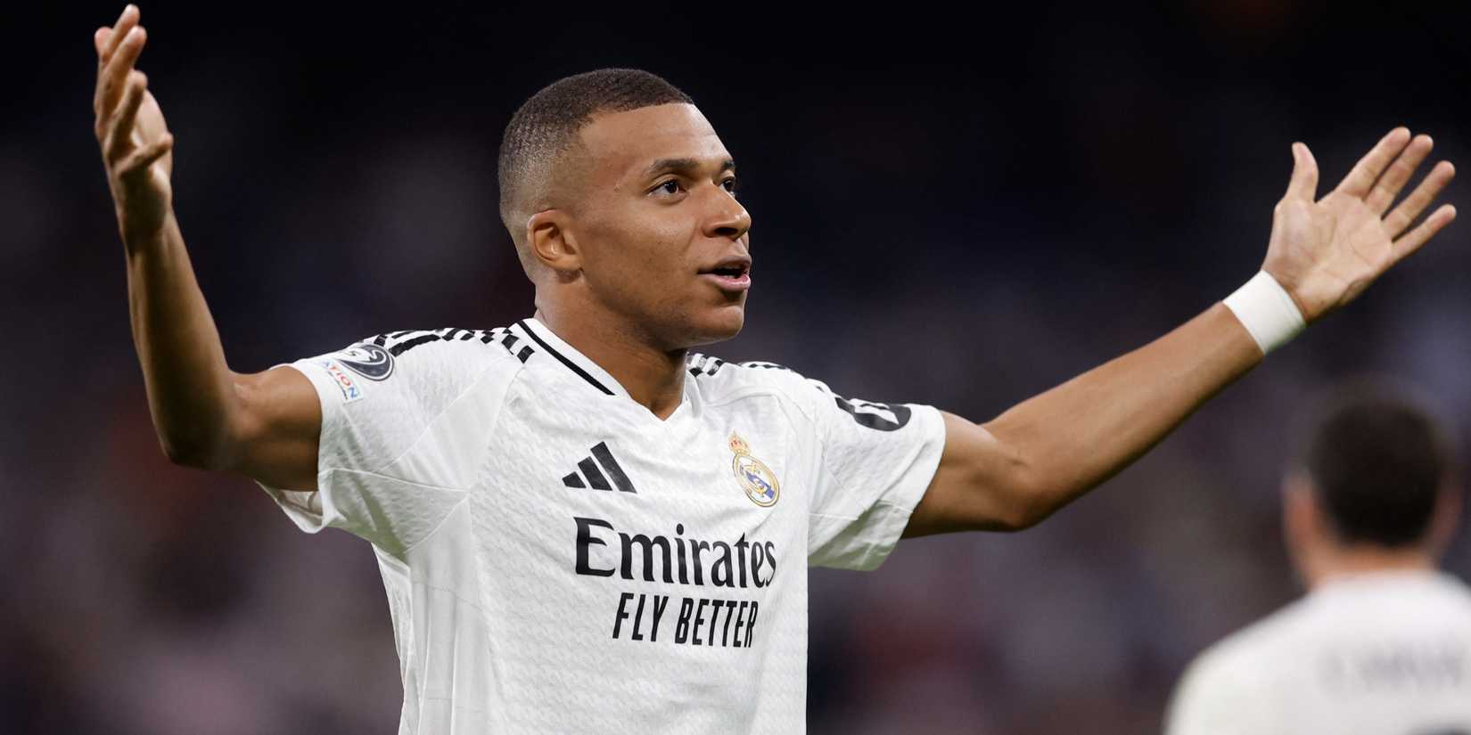 Real Madrid striker Kylian Mbappe celebrates with arms outstretched