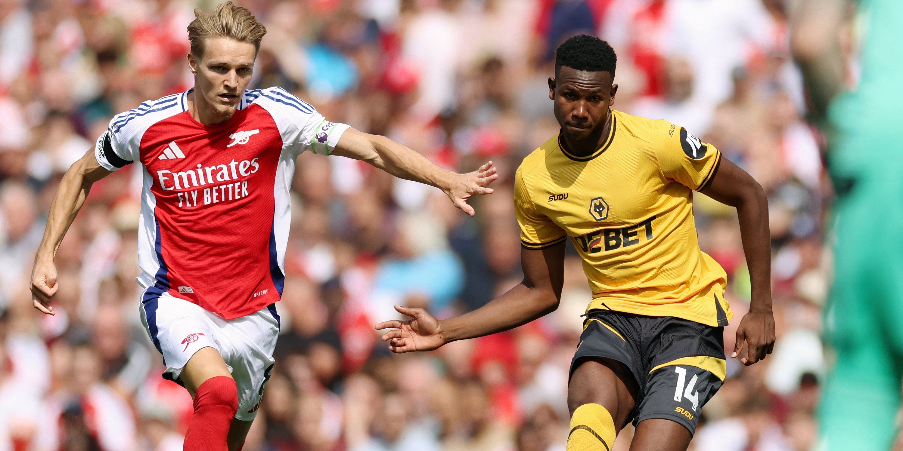 Arsenal midfielder Martin Odegaard and Wolverhampton Wanderers defender Yerson Mosquera battling for possession