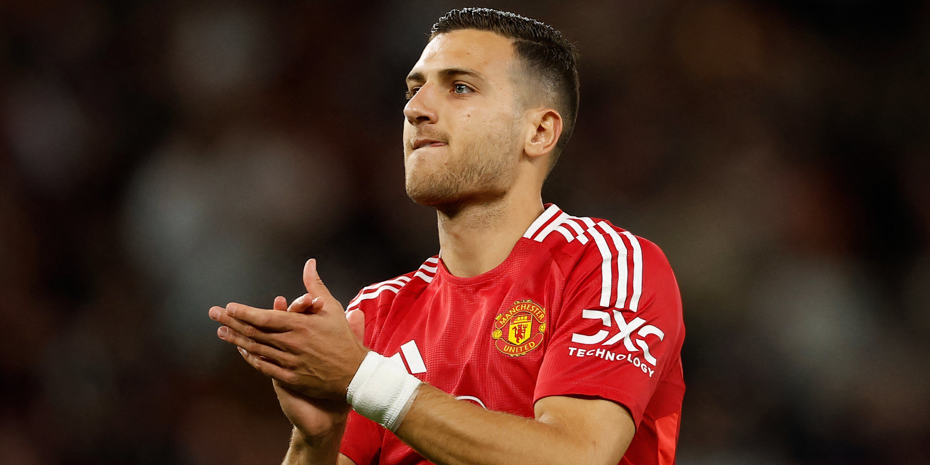 Manchester United right-back Diogo Dalot applauding supporters