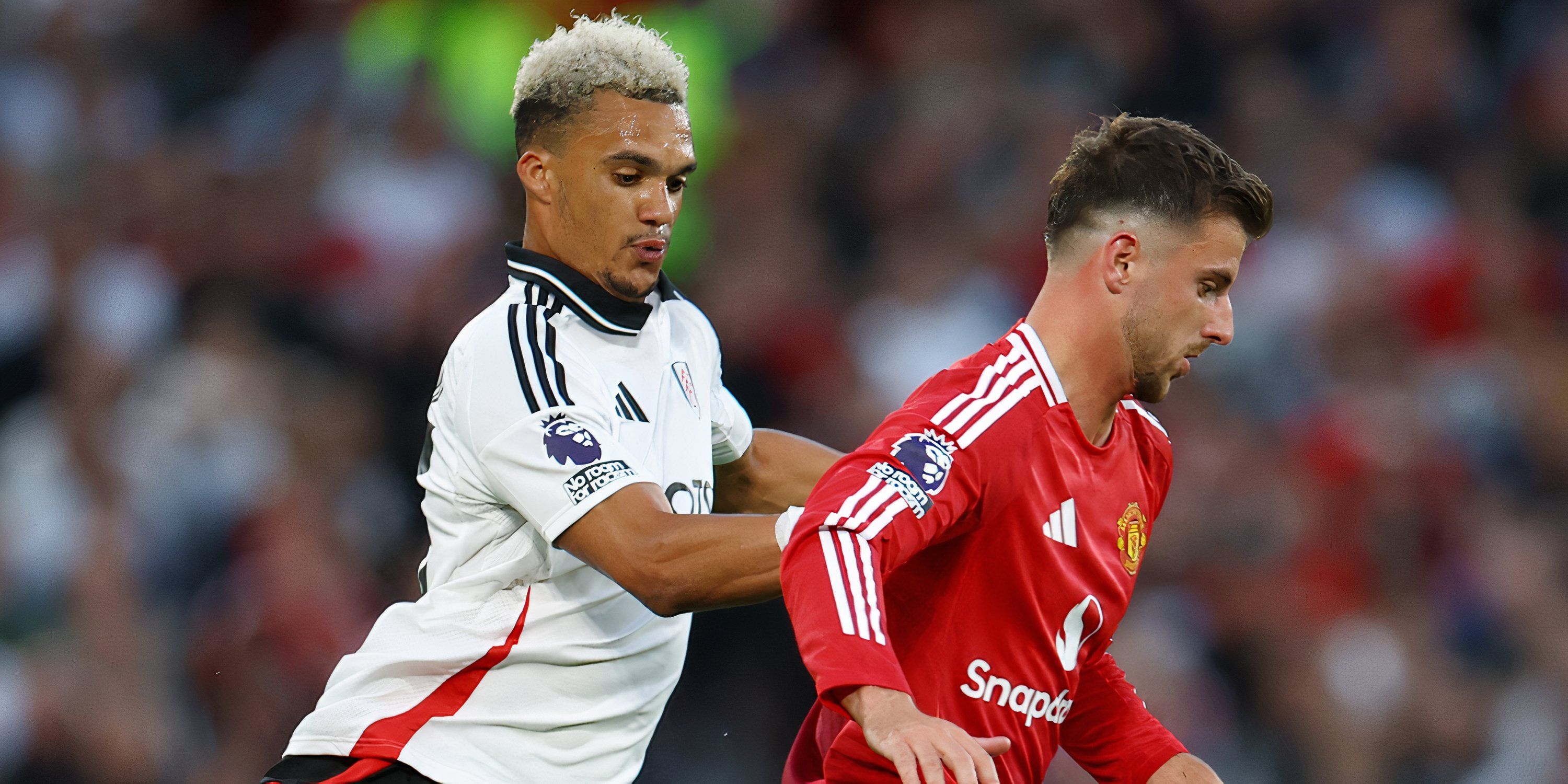 Fulham left-back Antonee Robinson battling with Manchester United midfielder Mason Mount for possession