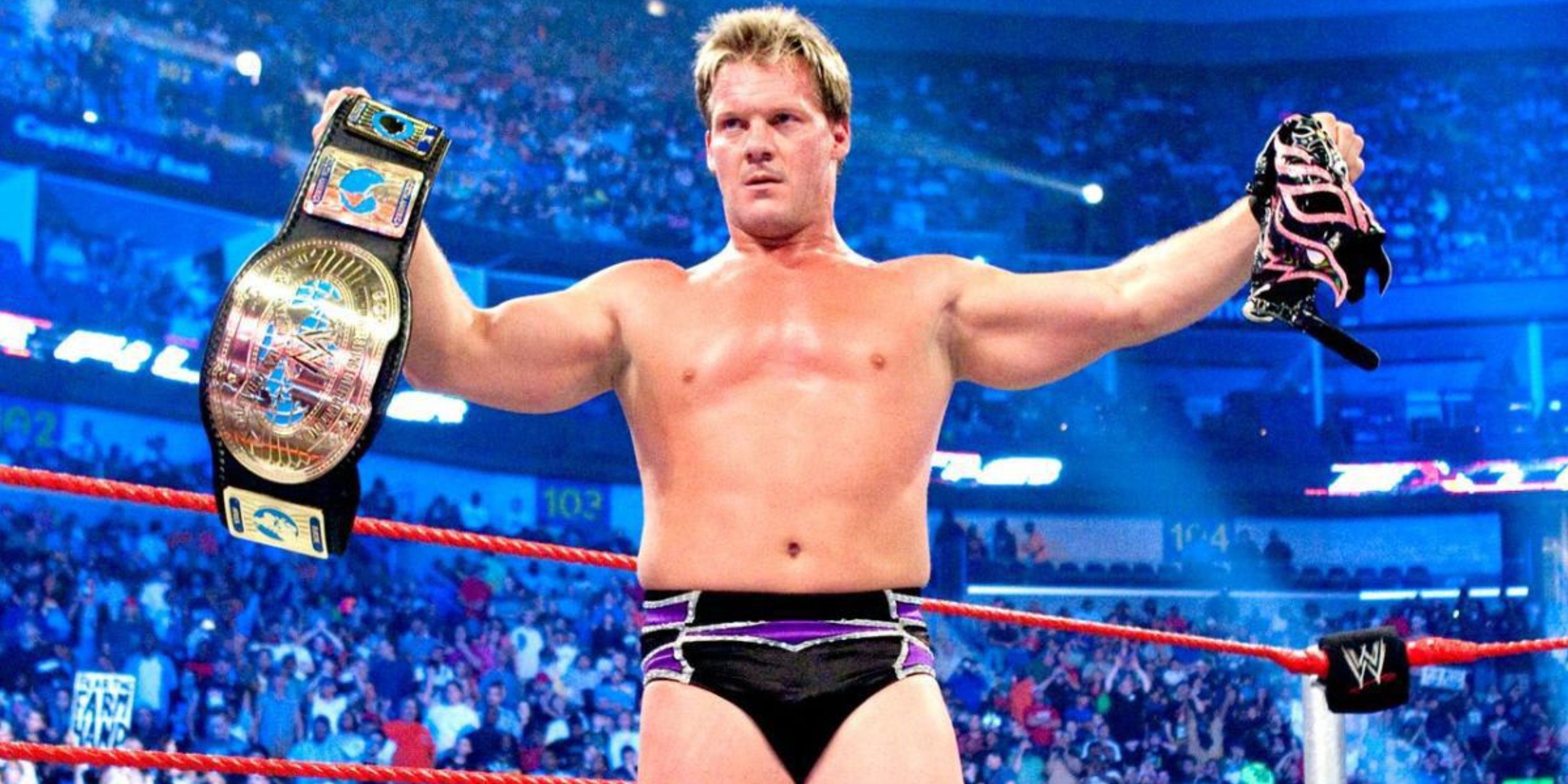 Chris Jericho holding up the Intercontinental Championship and Rey Mysterio's mask